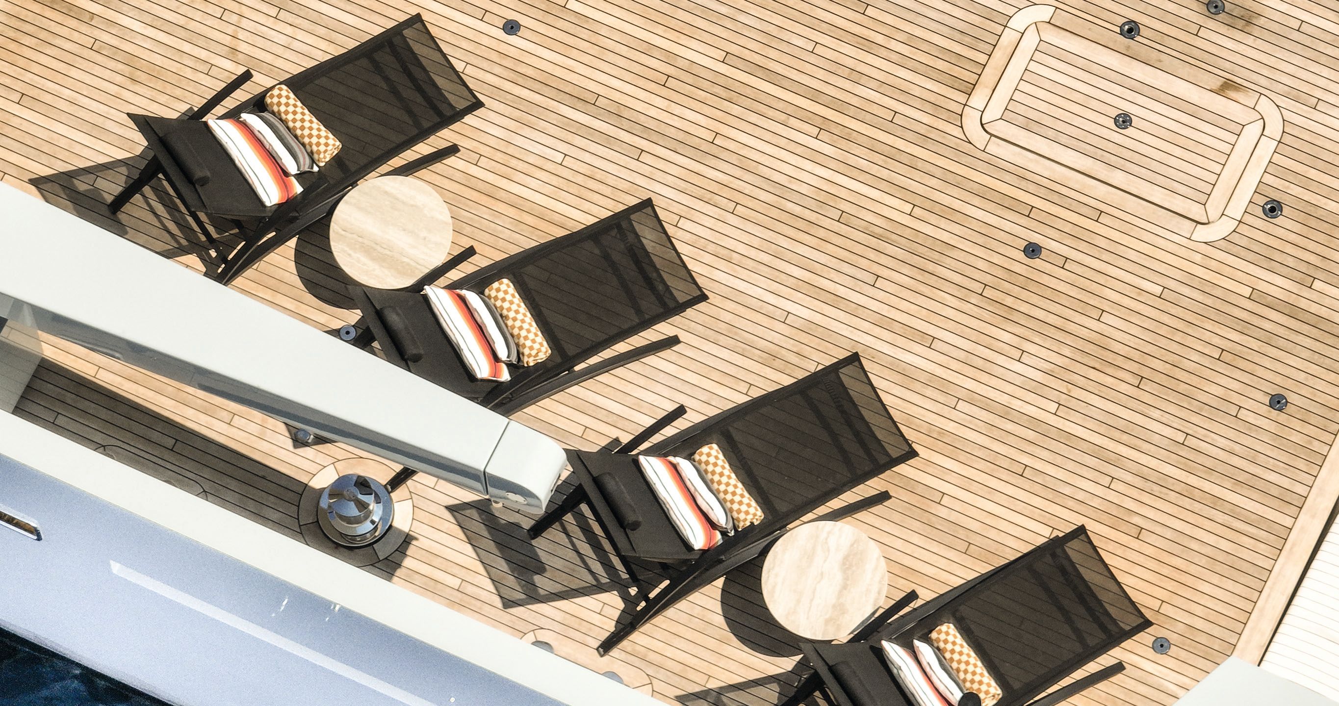 Overhead shot of four deck chairs on the deck with various patterned cushions