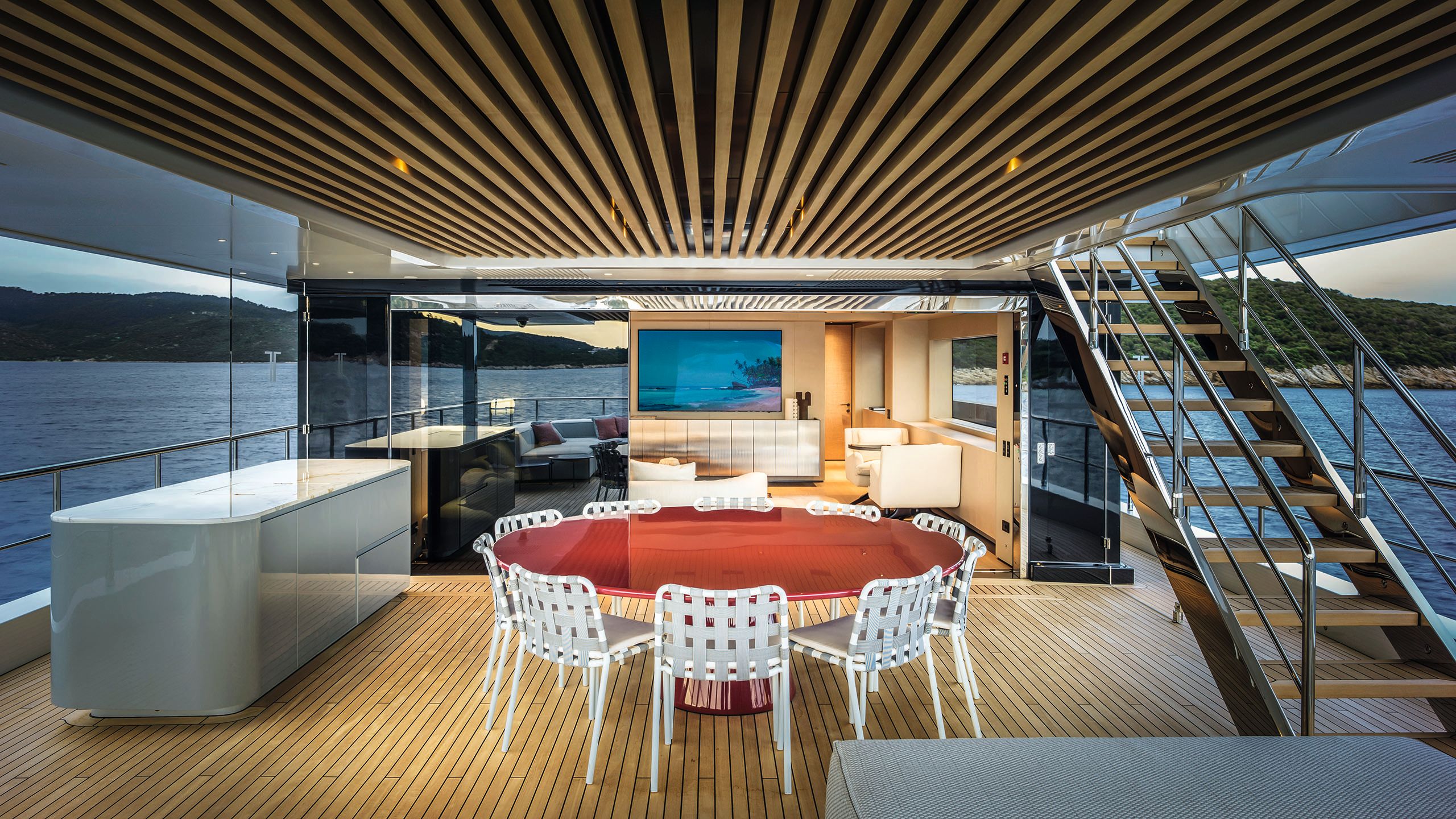 Large red resin table with white chairs around it