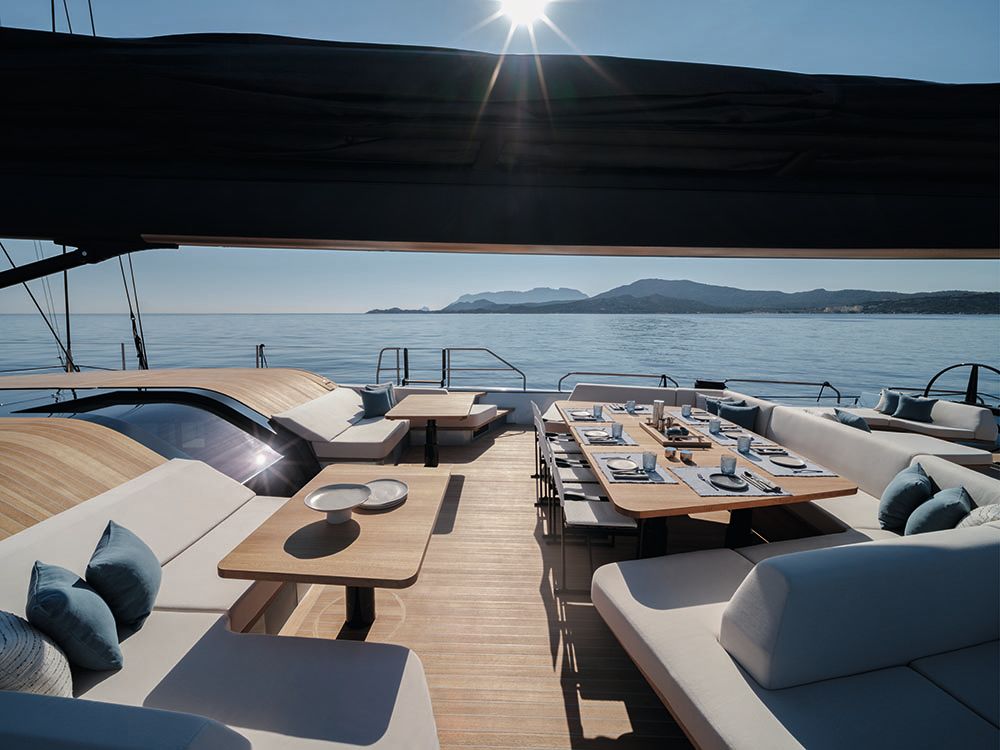 Outdoor seating area with grey soft seating arranged in an L-shape around numerous tables