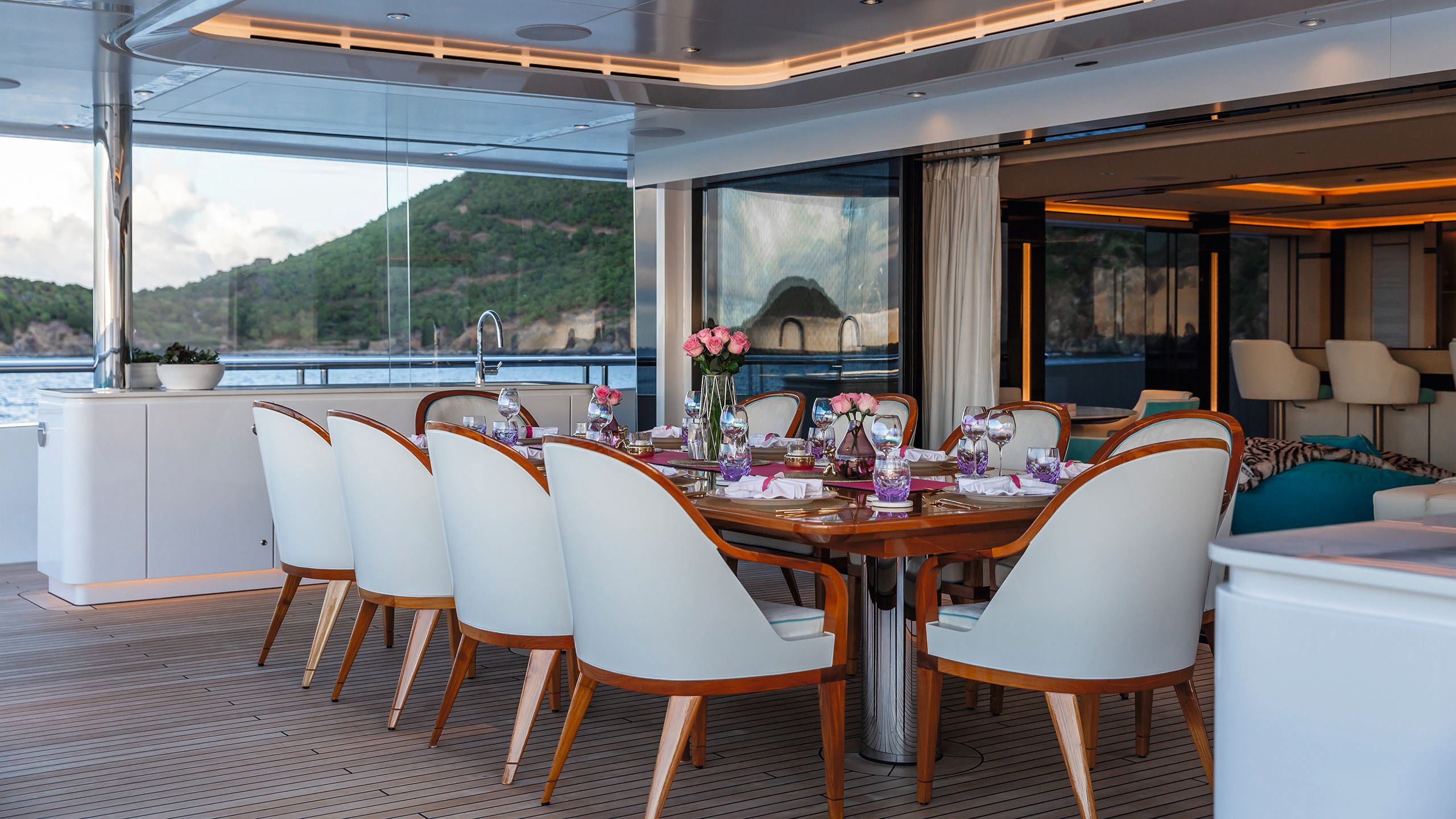 A dining table set with place settings and chairs for 10 guests