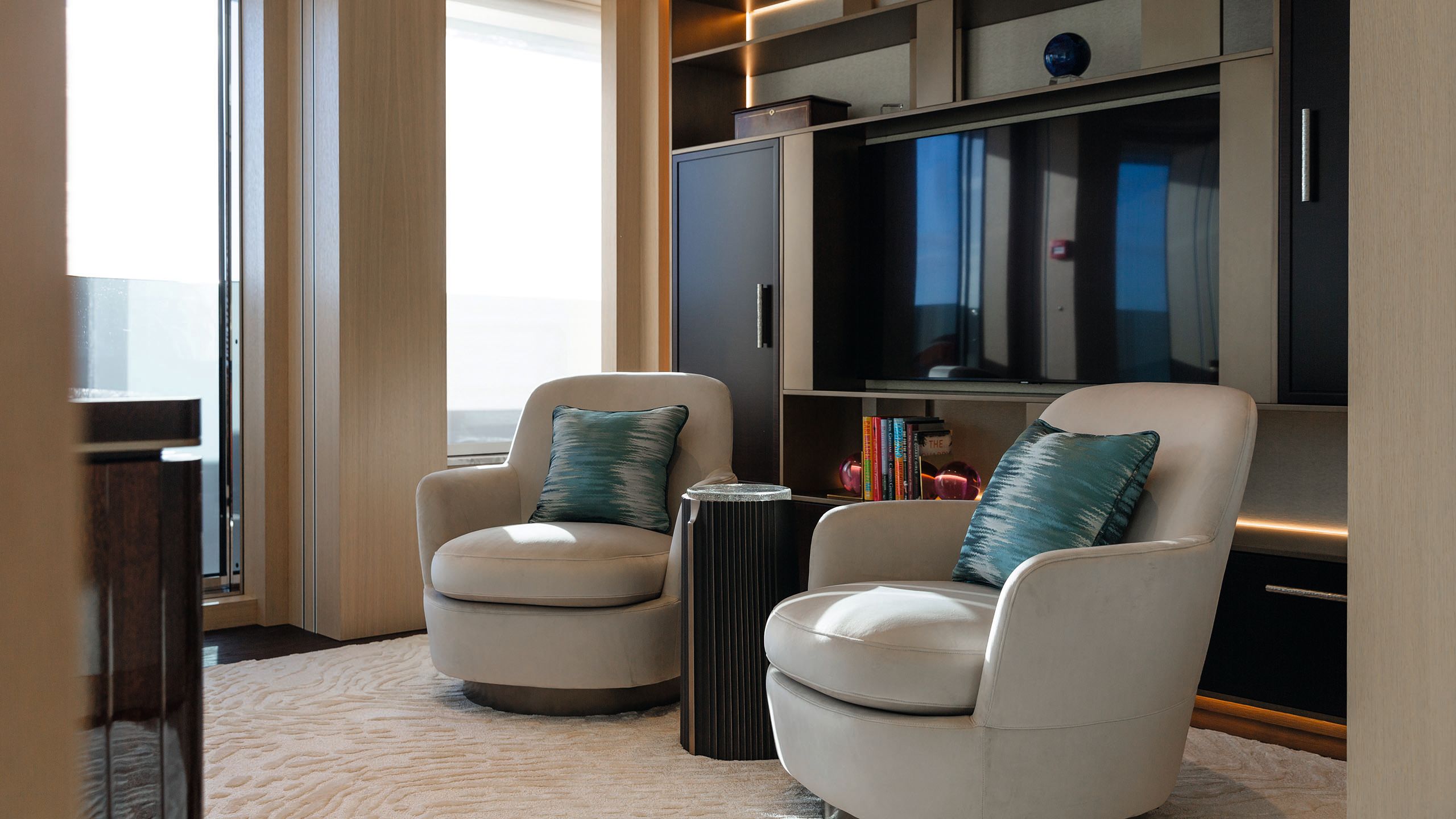 Two neutral armchairs with blue cushions