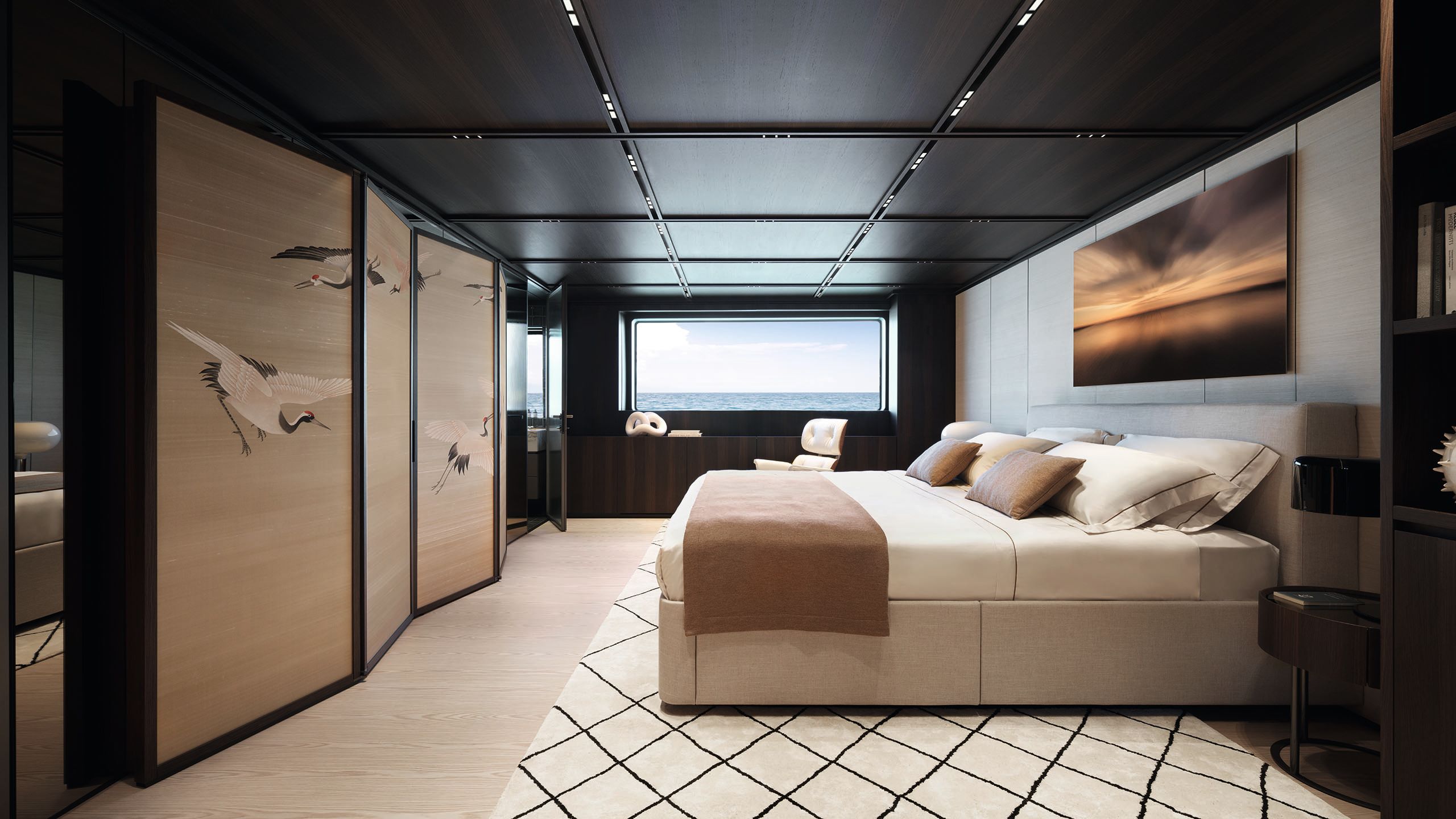 The owner's cabin features neutral colours, a white rug with black diamond pattern, and silk-screen cranes on the screen leaning against the wall opposite the bed