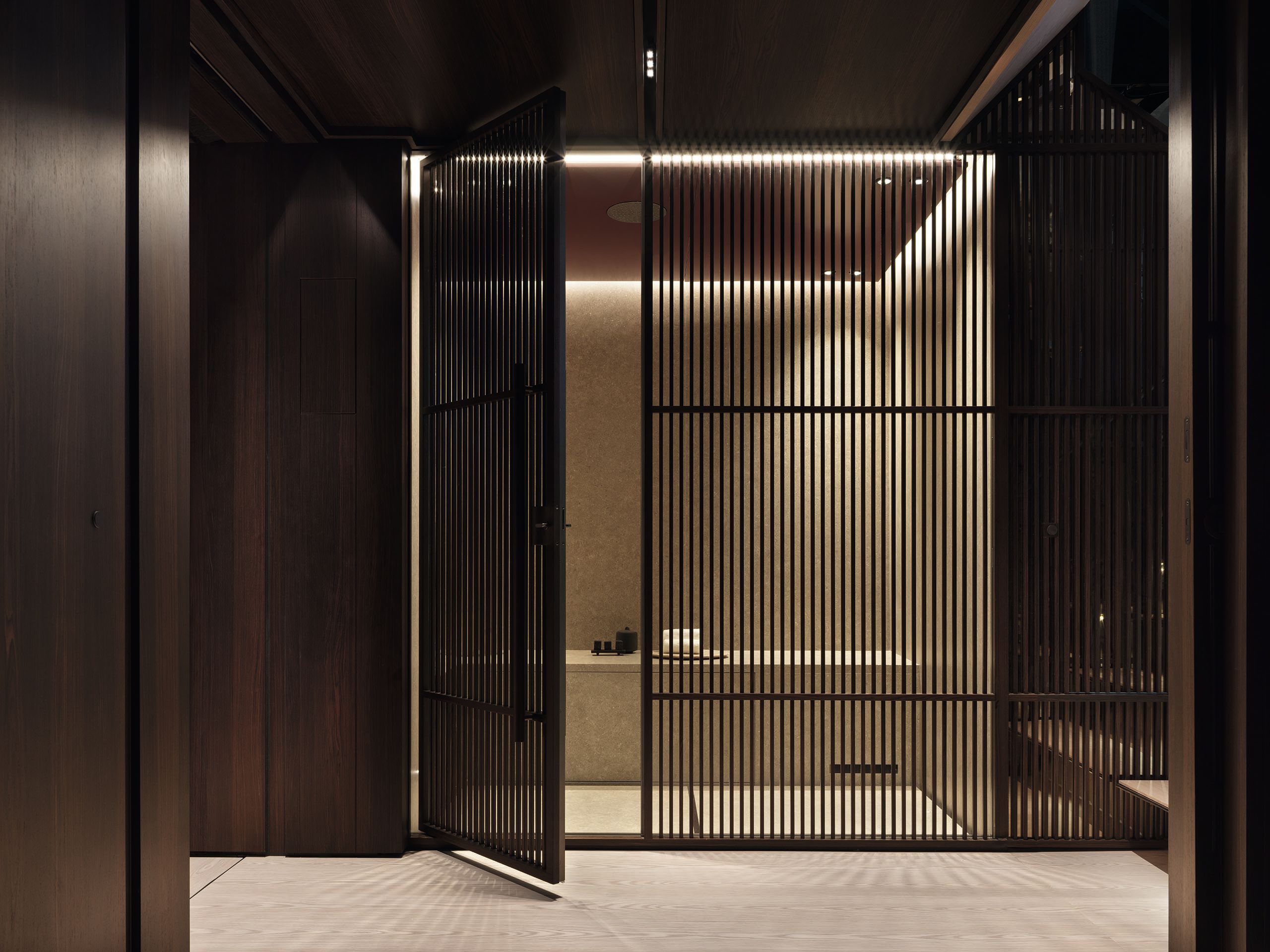 Side view of the hammam which is dimly lit and decorated in black and neutral colours