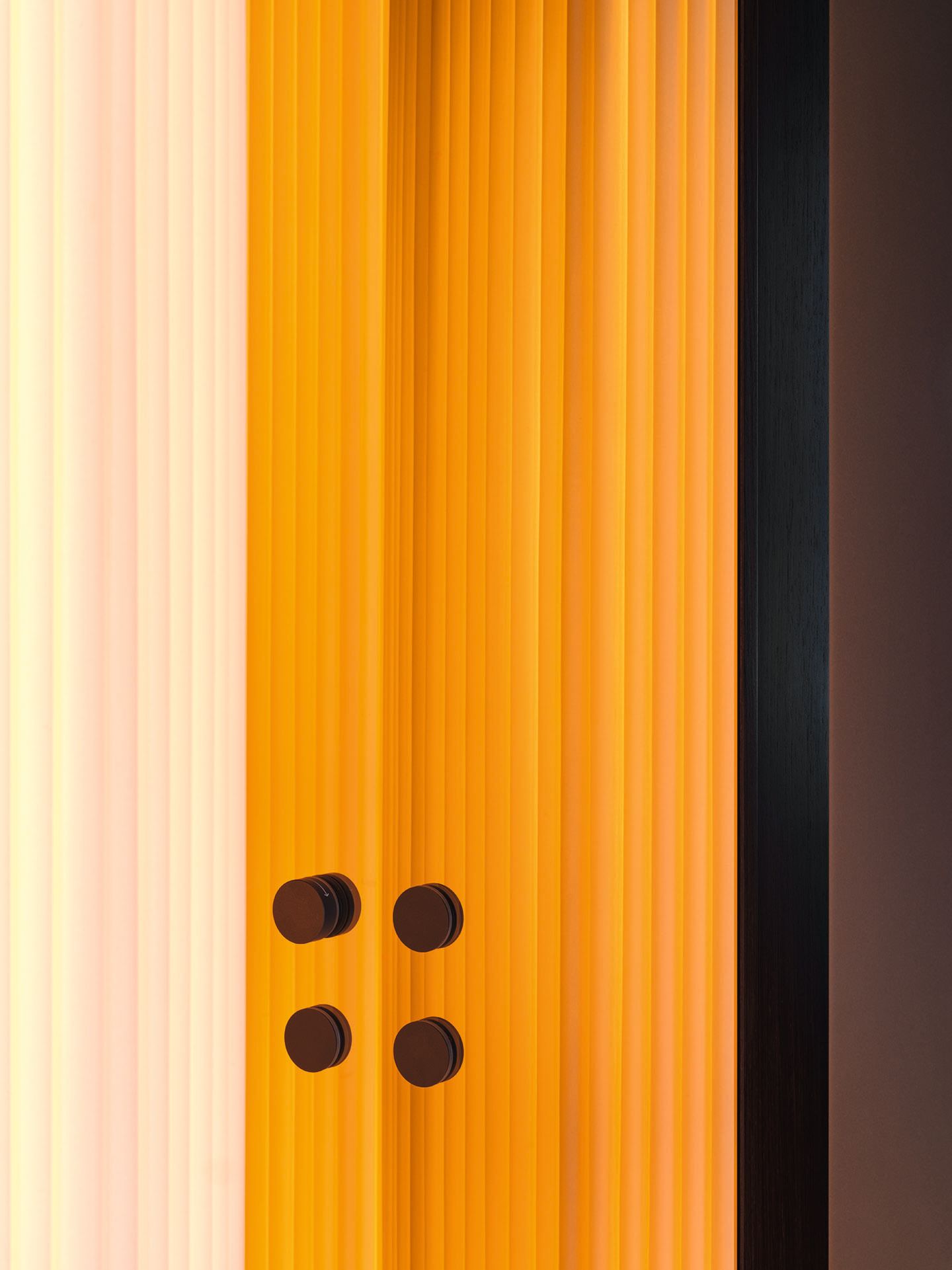 Reeded glass, lit orange and cream from behind