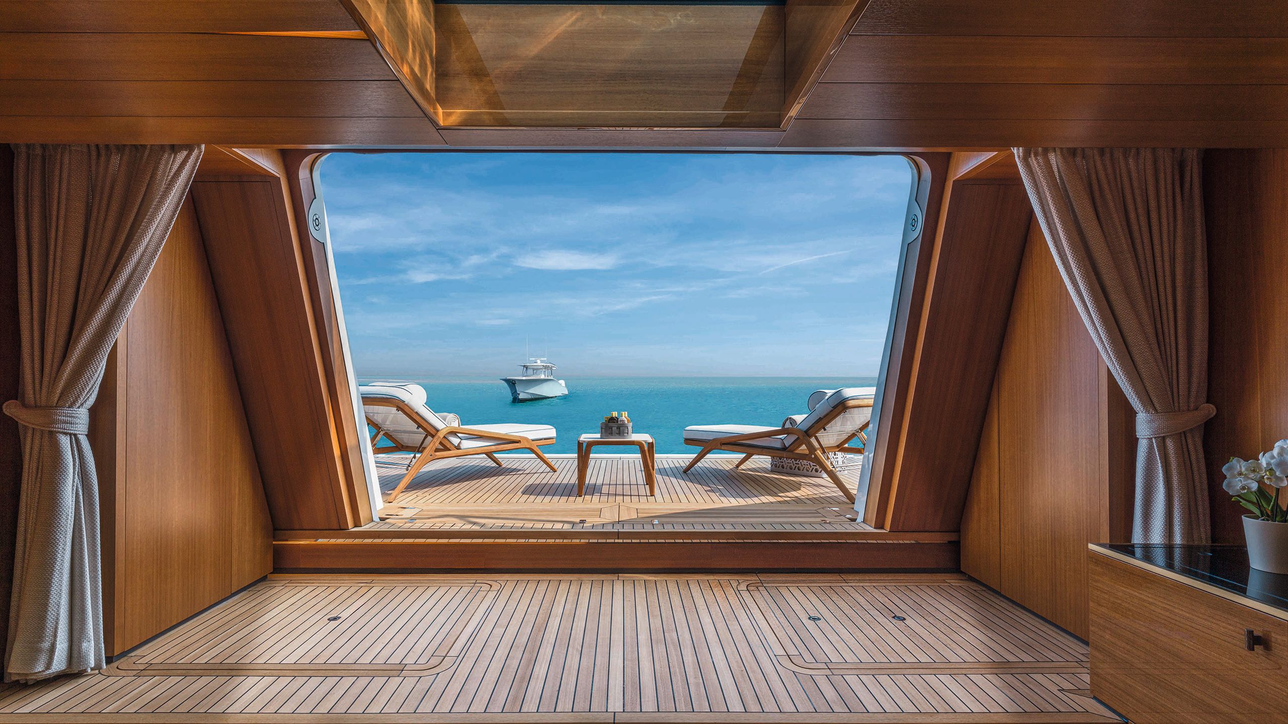 Looking out on to the terrace which has beach loungers and a table