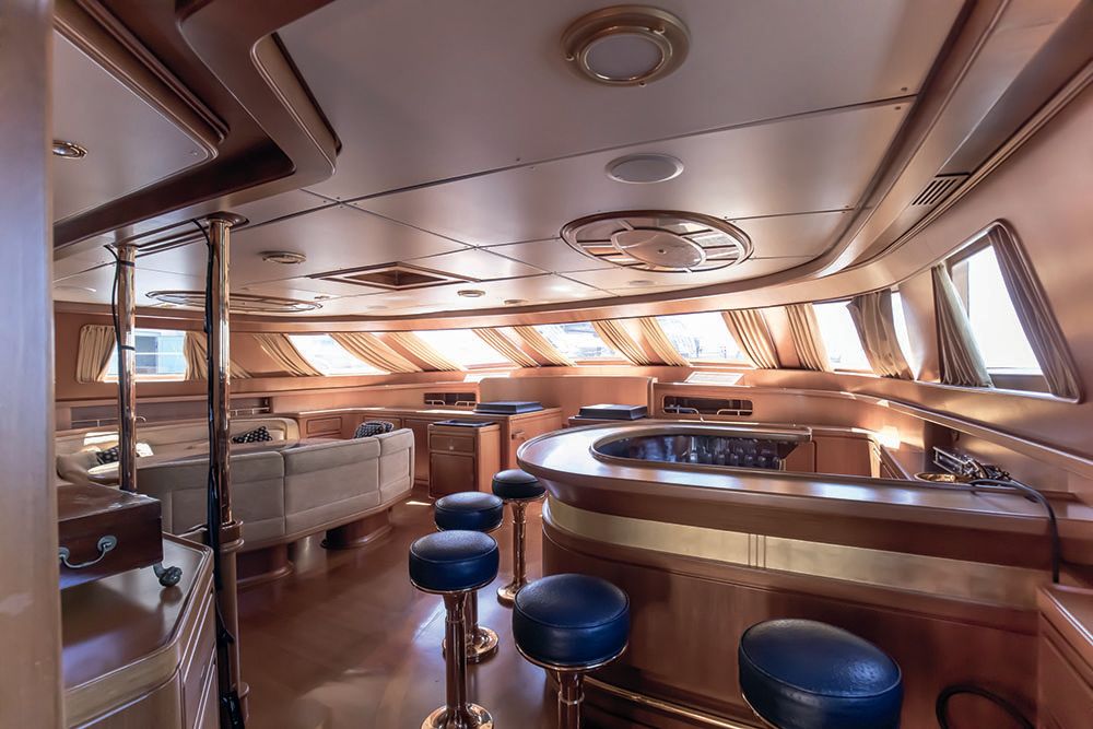 A pre-refit interior picture of a u-shaped bar with stools surrounding it