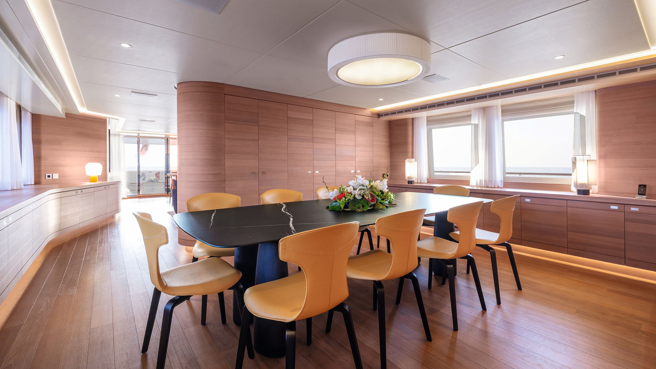 The dining table is now dark grey with a marbled effect and the chairs and a golden yolk colour. The lamps are a softer Scandi-style