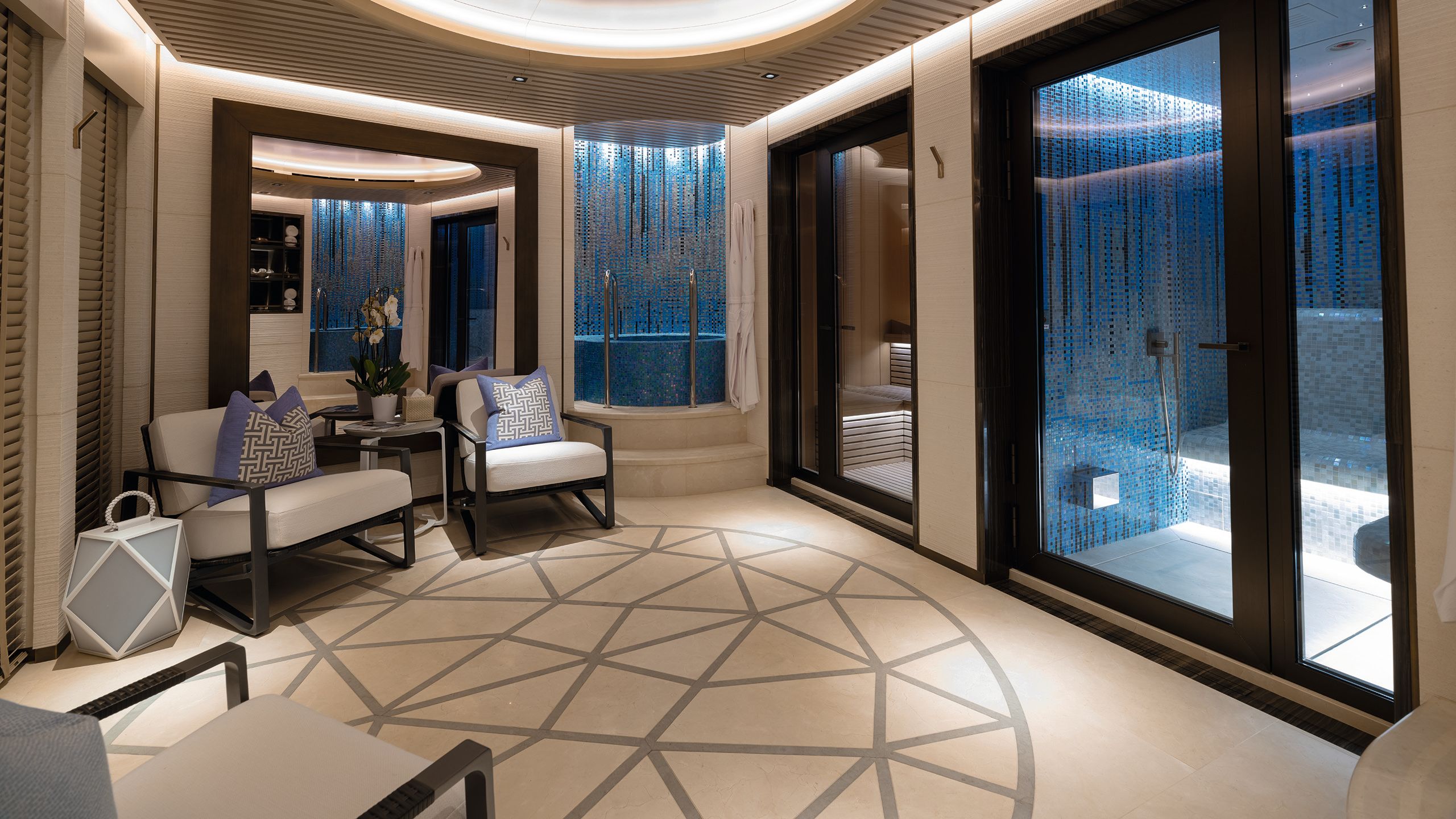 Spa area with two chairs facing steam/sauna