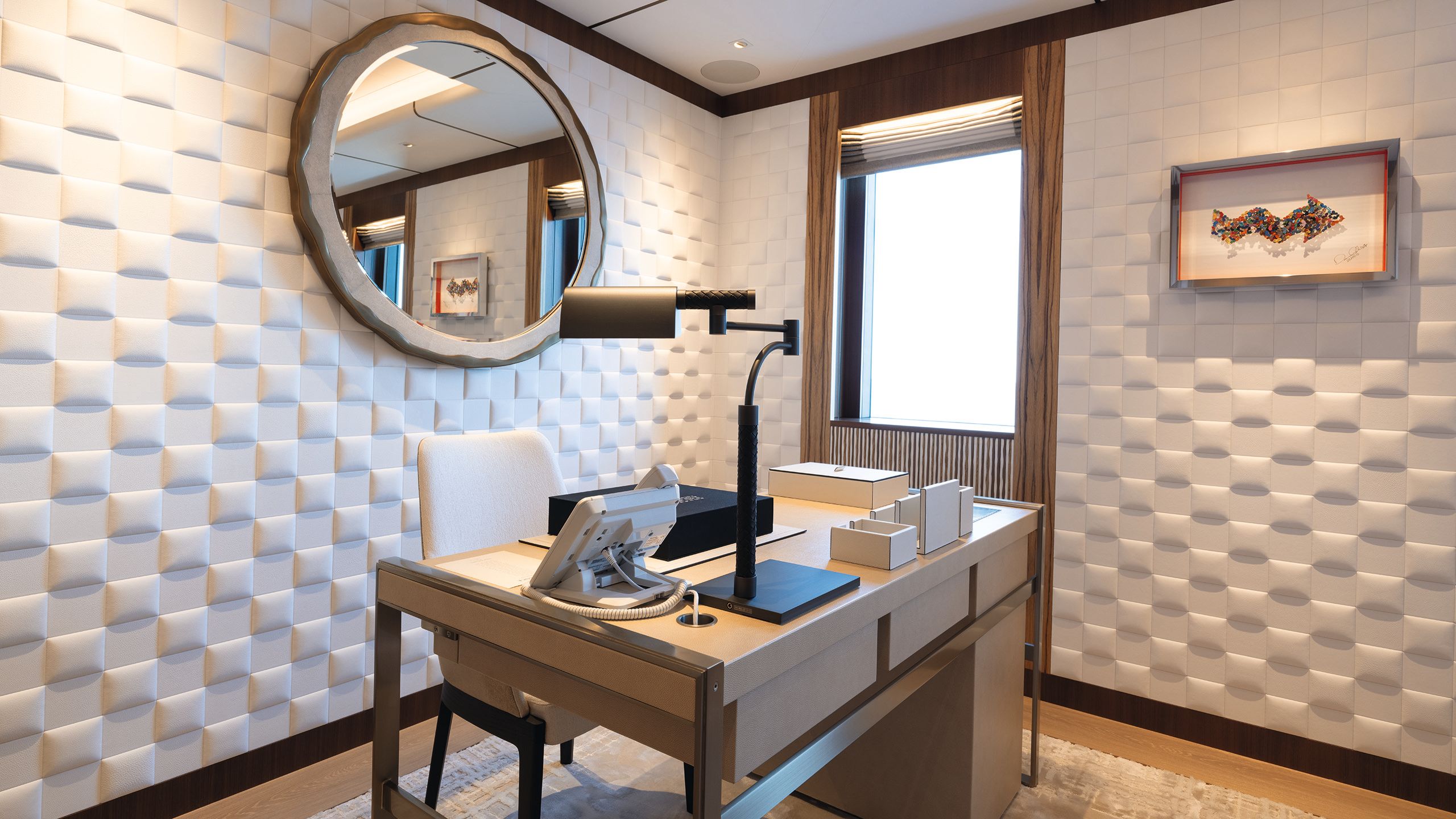 "Her" office with white walls, desk and mirror