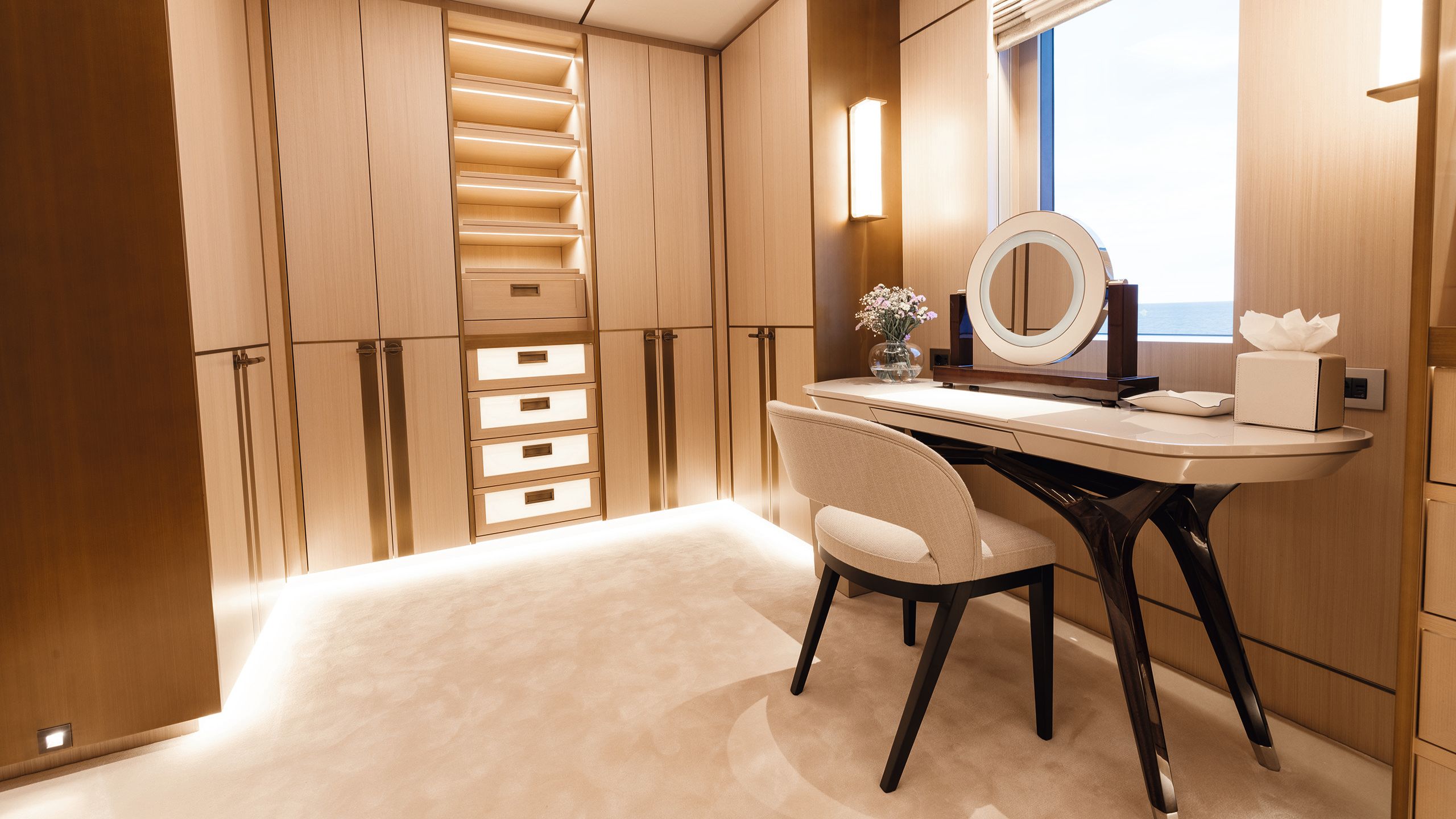 Dressing table and chair with backlit shelves and wardrobes