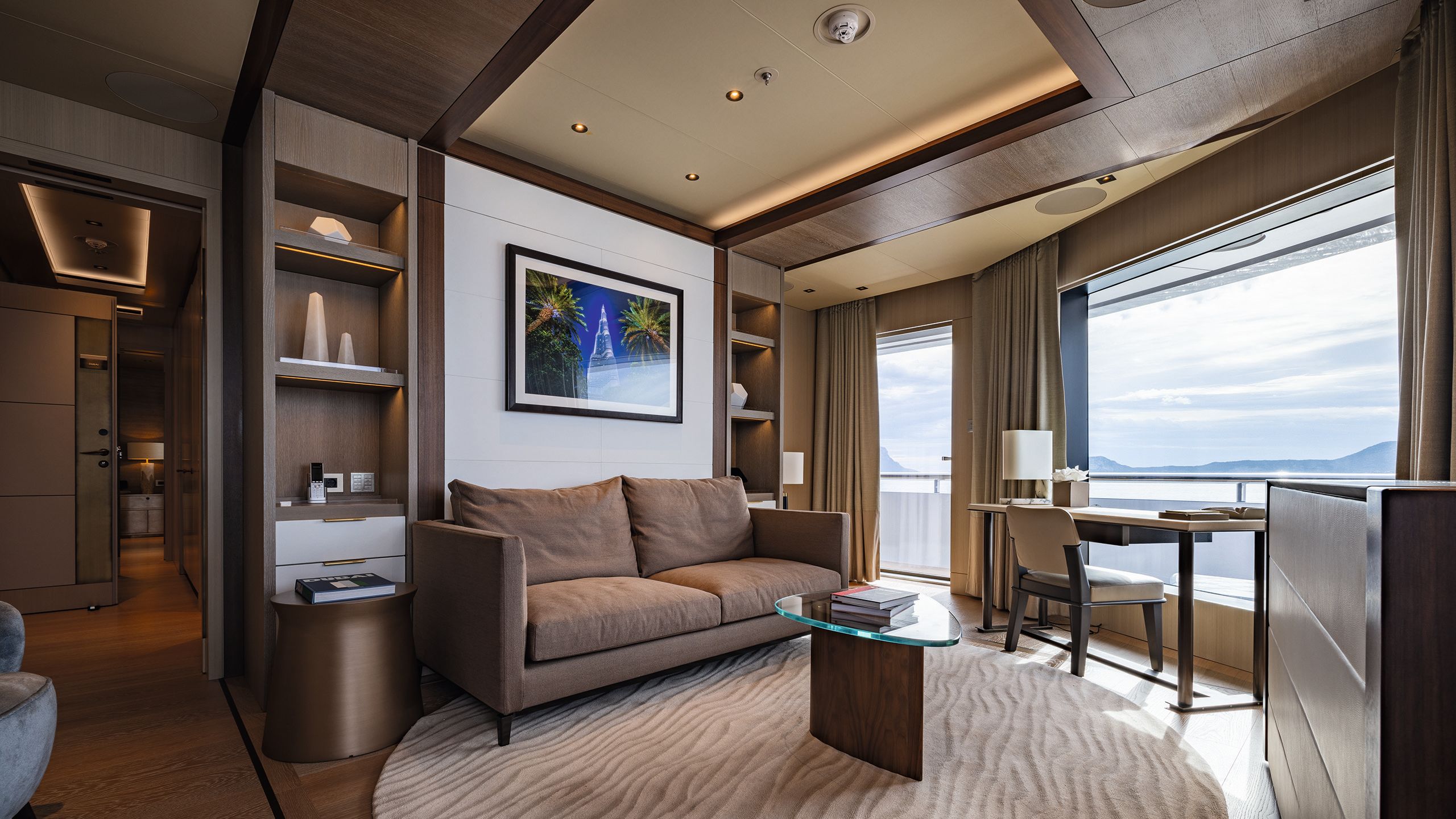 Seating area with brown sofa, brown drapes and brown rug