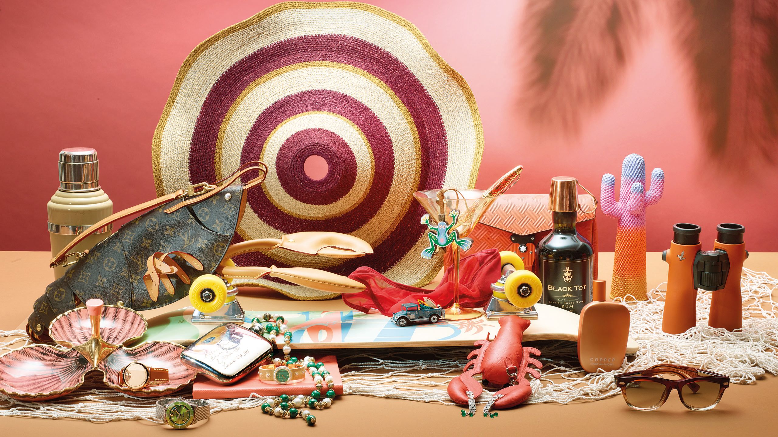 Gifts in a peach and pink palatte including a Louis Vuitton bag, straw hat, Cartier earrings, lobster charm, rum and perfume