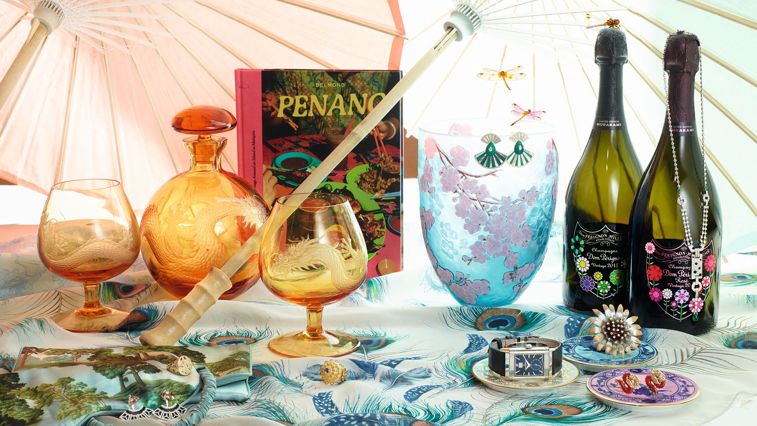 Gift guide in a soft orange, green and blue palatte, including glassware, watches, a book and champagne