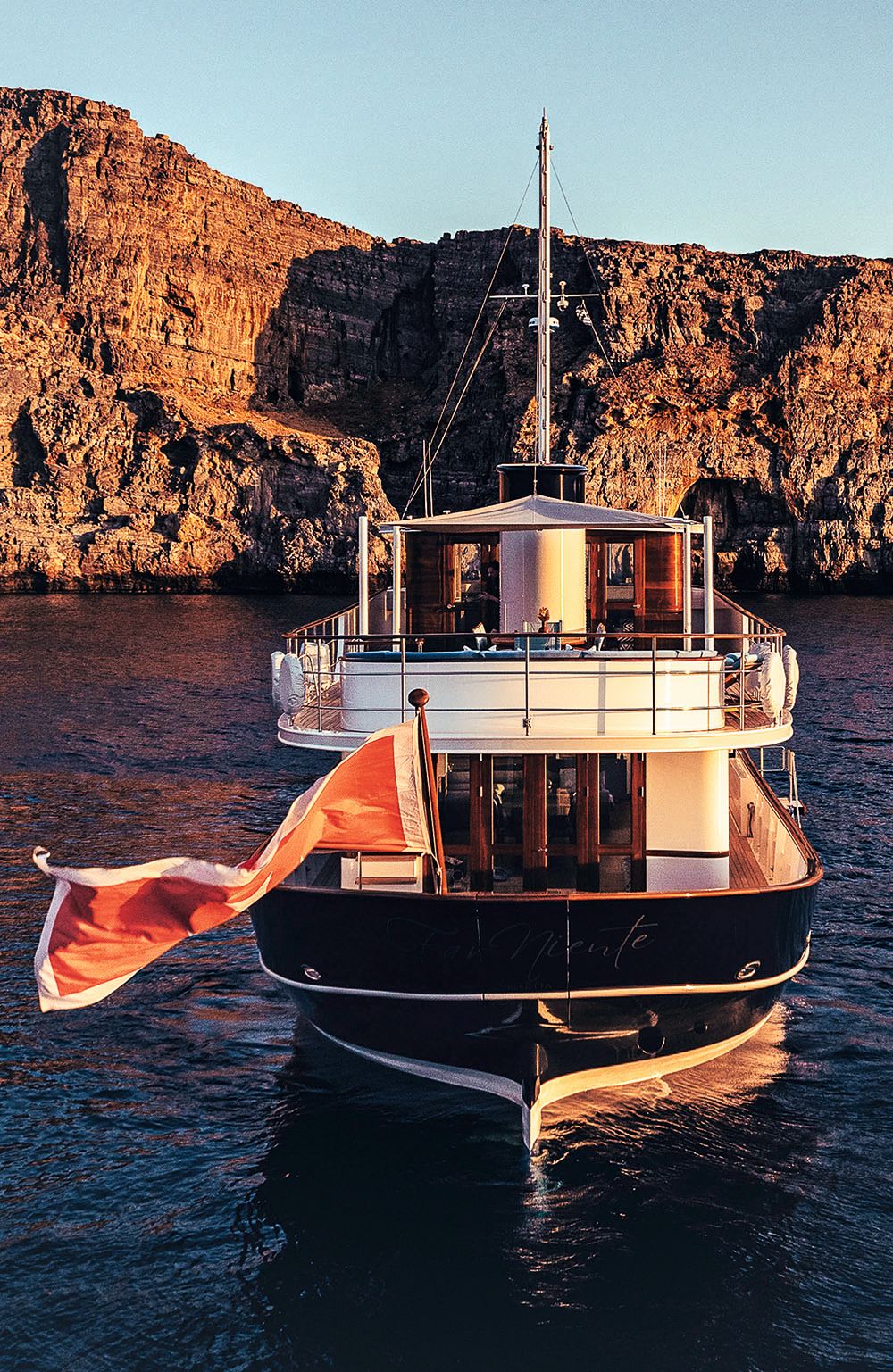 Far Niente from the front at sunset. There's a red and whie flag waving at the front