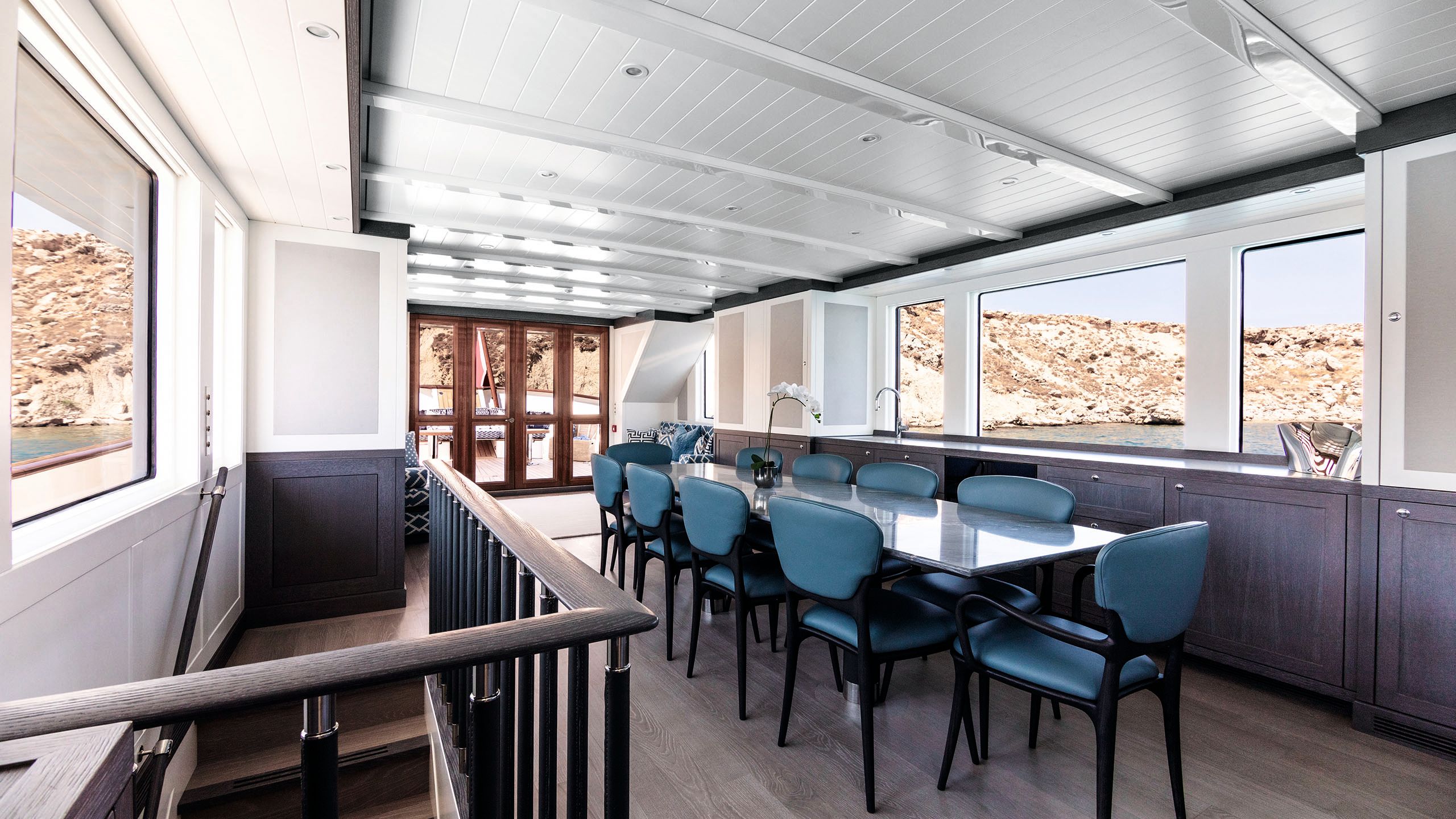 Dining table area with stairs to the right and double doors at the back