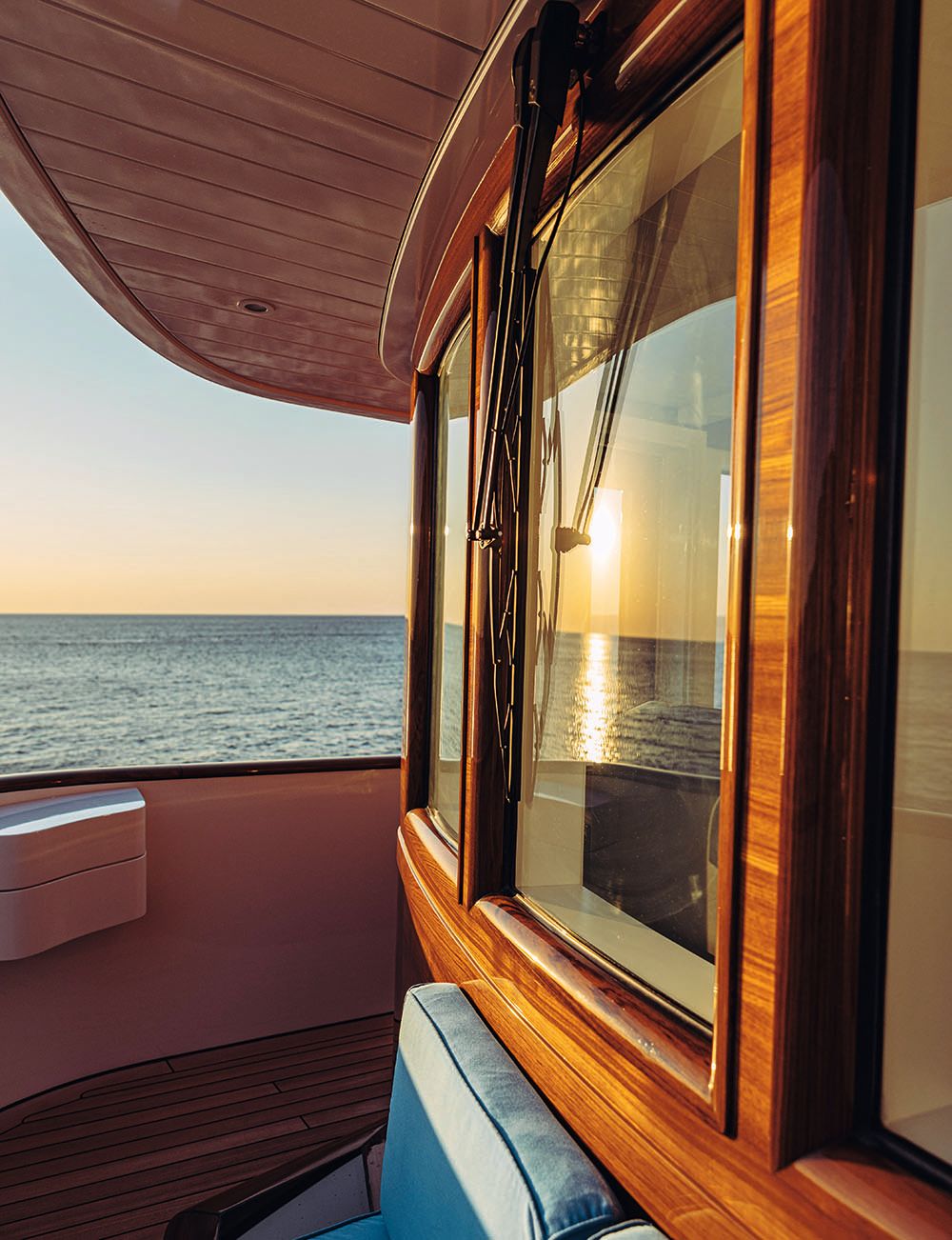 Sunset shining on the dockhouse window - the teak surround is gleaming orange