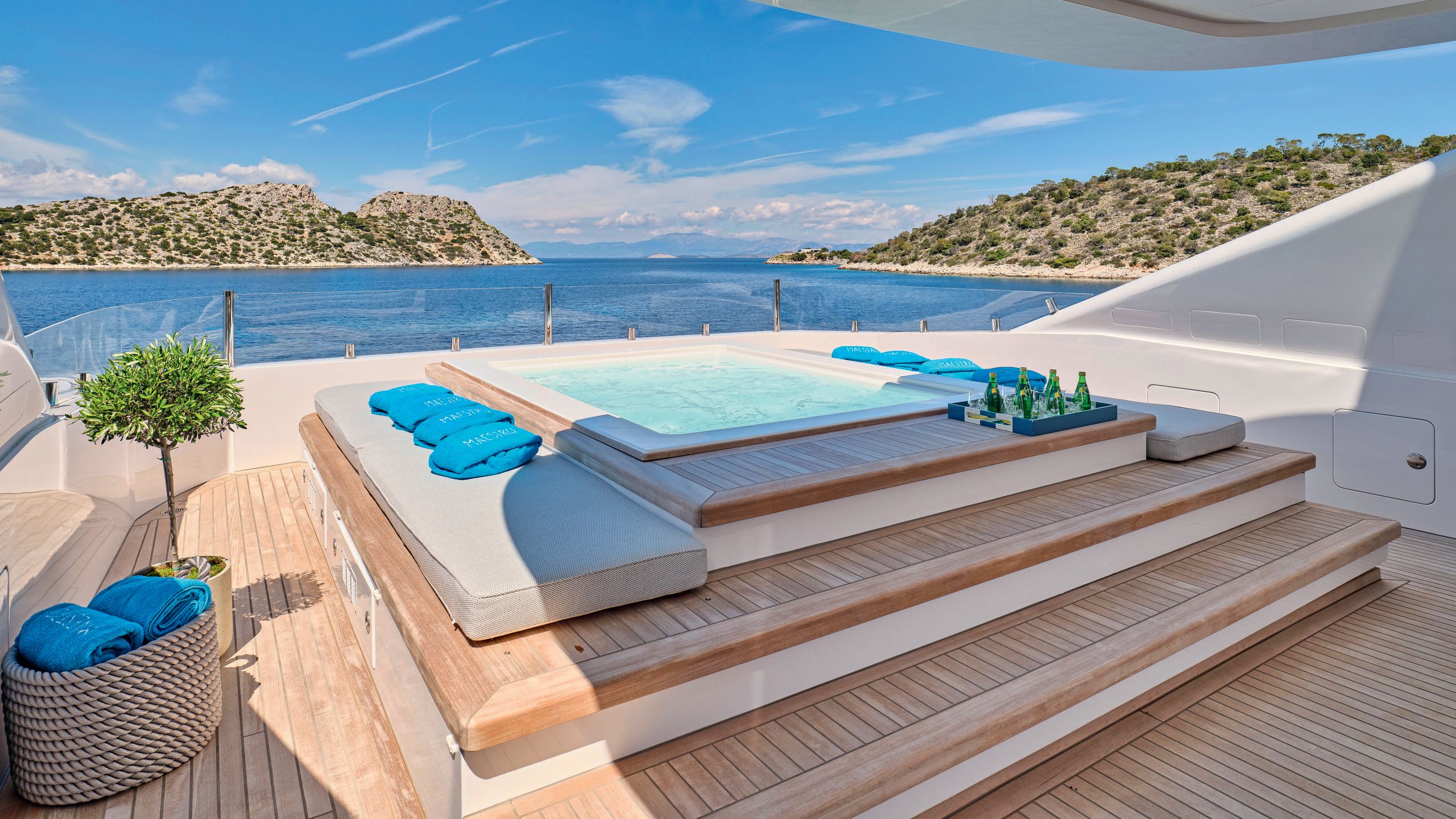 A spa pool with steps leading up to it and sun lounger pads either side