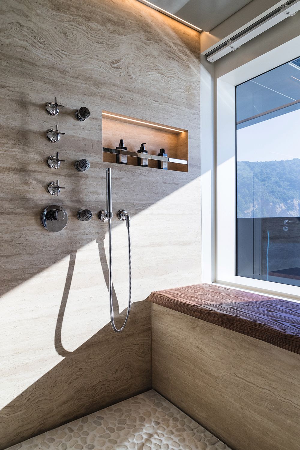 Walk-in shower with chrome fittings