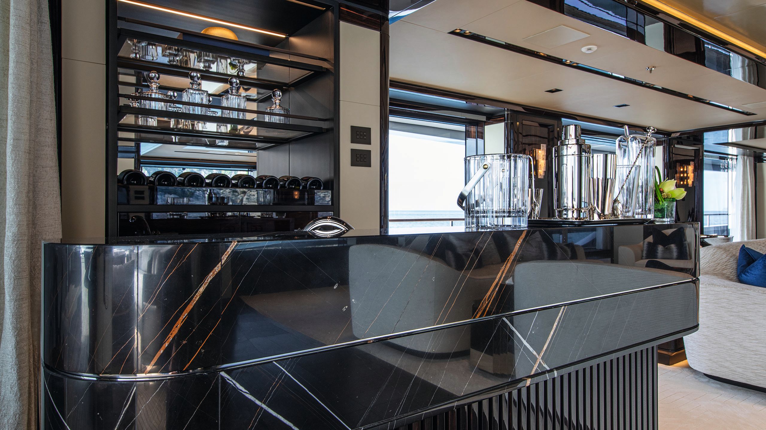 View of an indoor bar with a shiny black black bartop