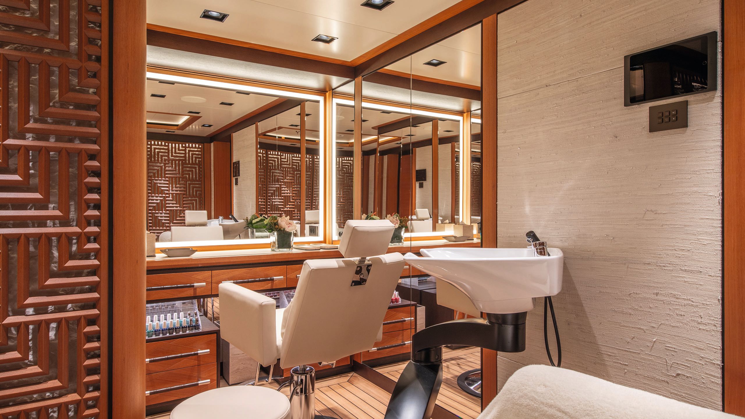 Onboard salon with hairdresser's chair and backwash opposite a large mirror