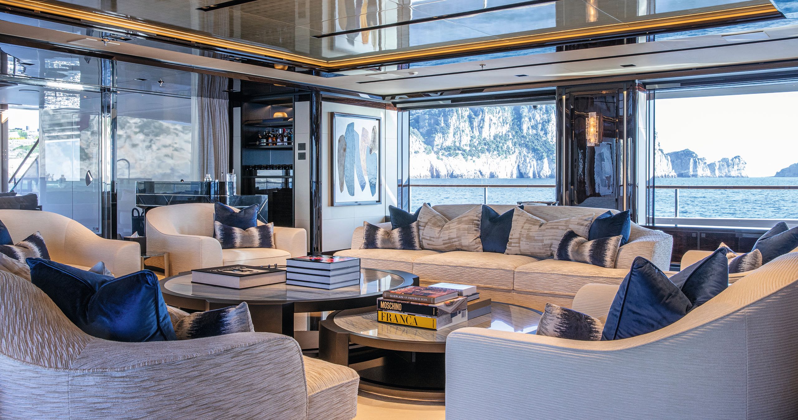 Soft seating area with neutral sofas and chairs with blue cushions