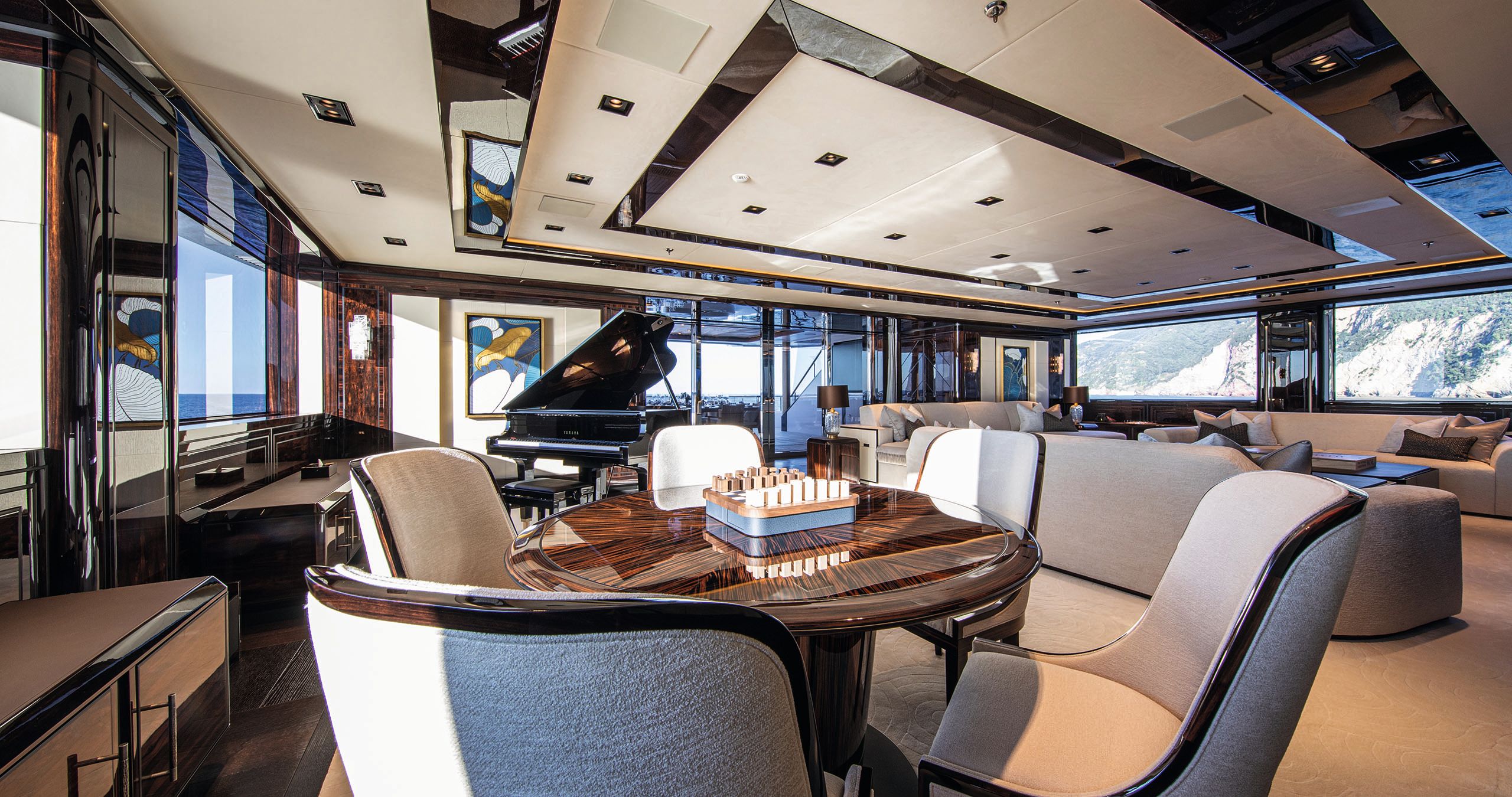 Interior of the owner's salon - it has a black piano and cream and brown sofas/chairs/table