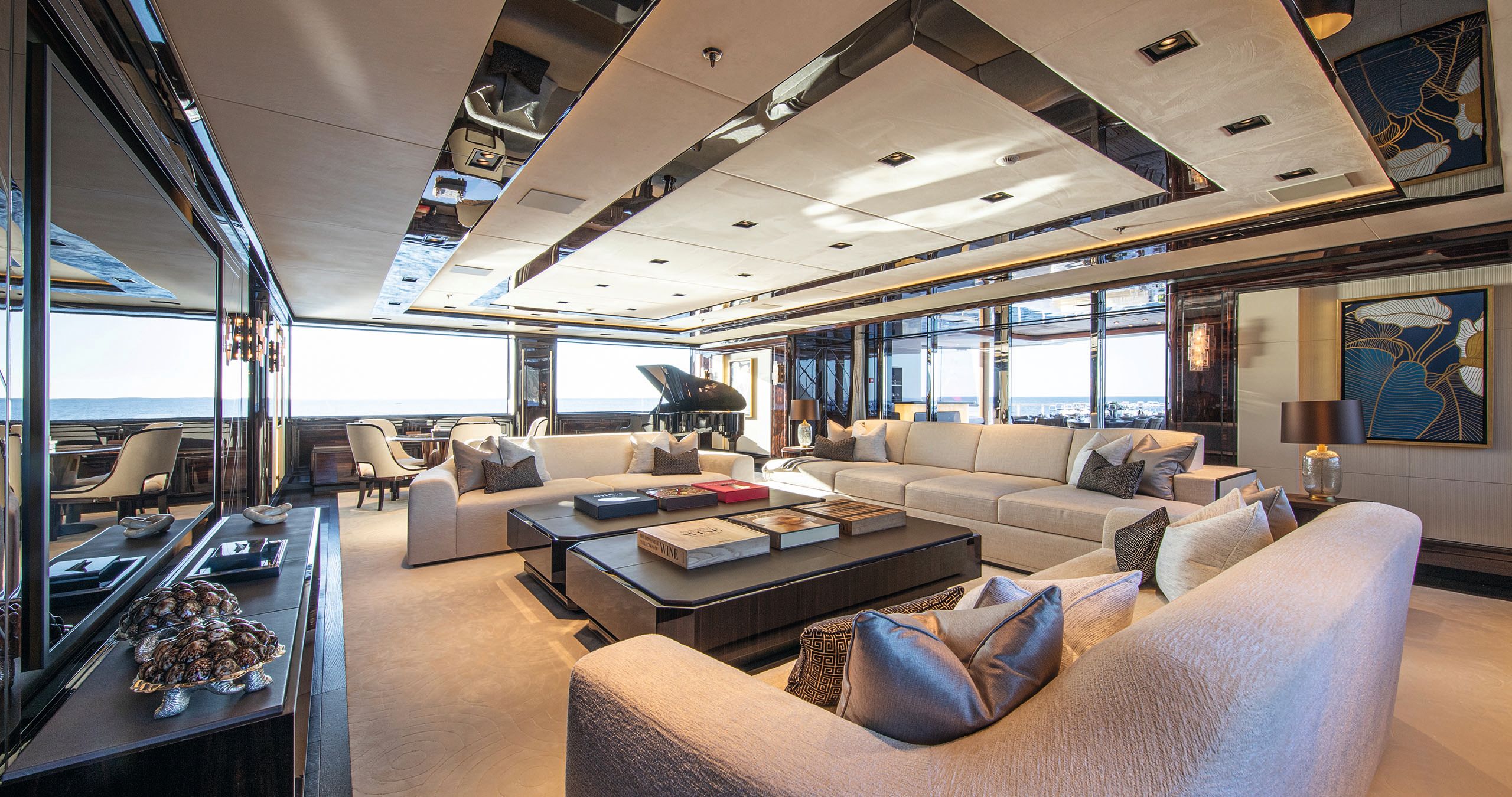 Interior of the owner's salon - it has a black piano and cream and brown sofas/chairs/table