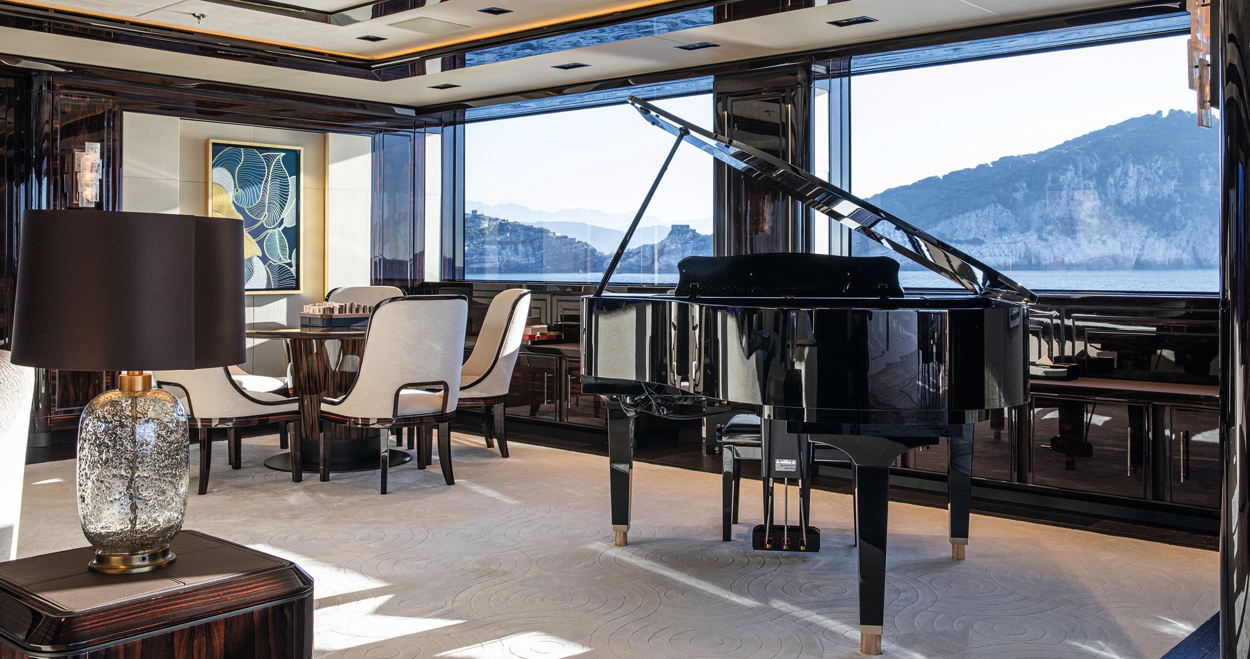 Interior of the owner's salon - it has a black piano and cream and brown sofas/chairs/table