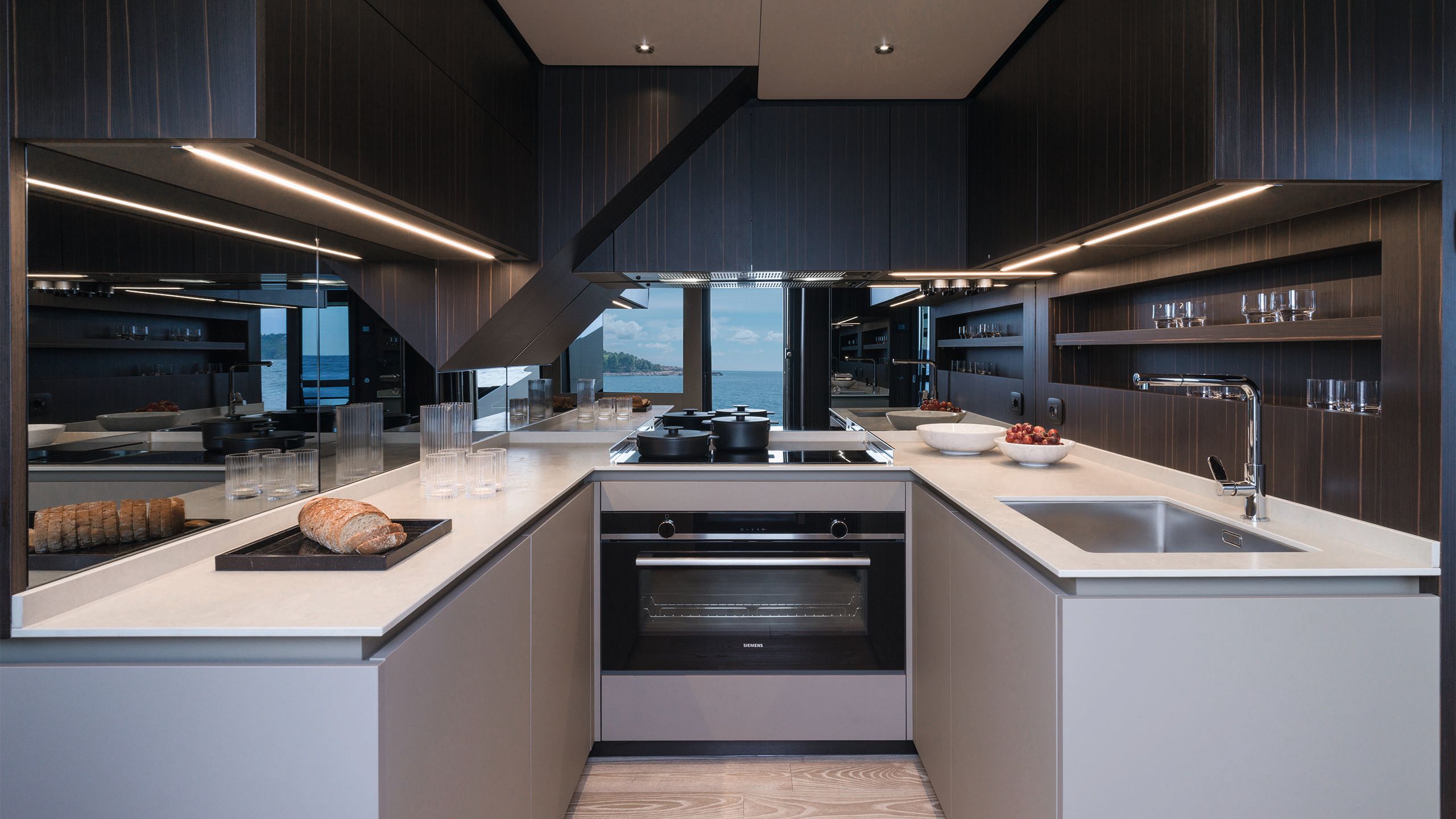 A u-shaped kitchen with light grey cupboards and counter tops