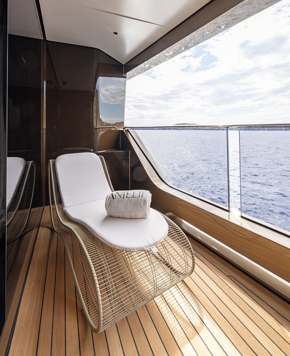 A rocking chair with white seat on a balcony