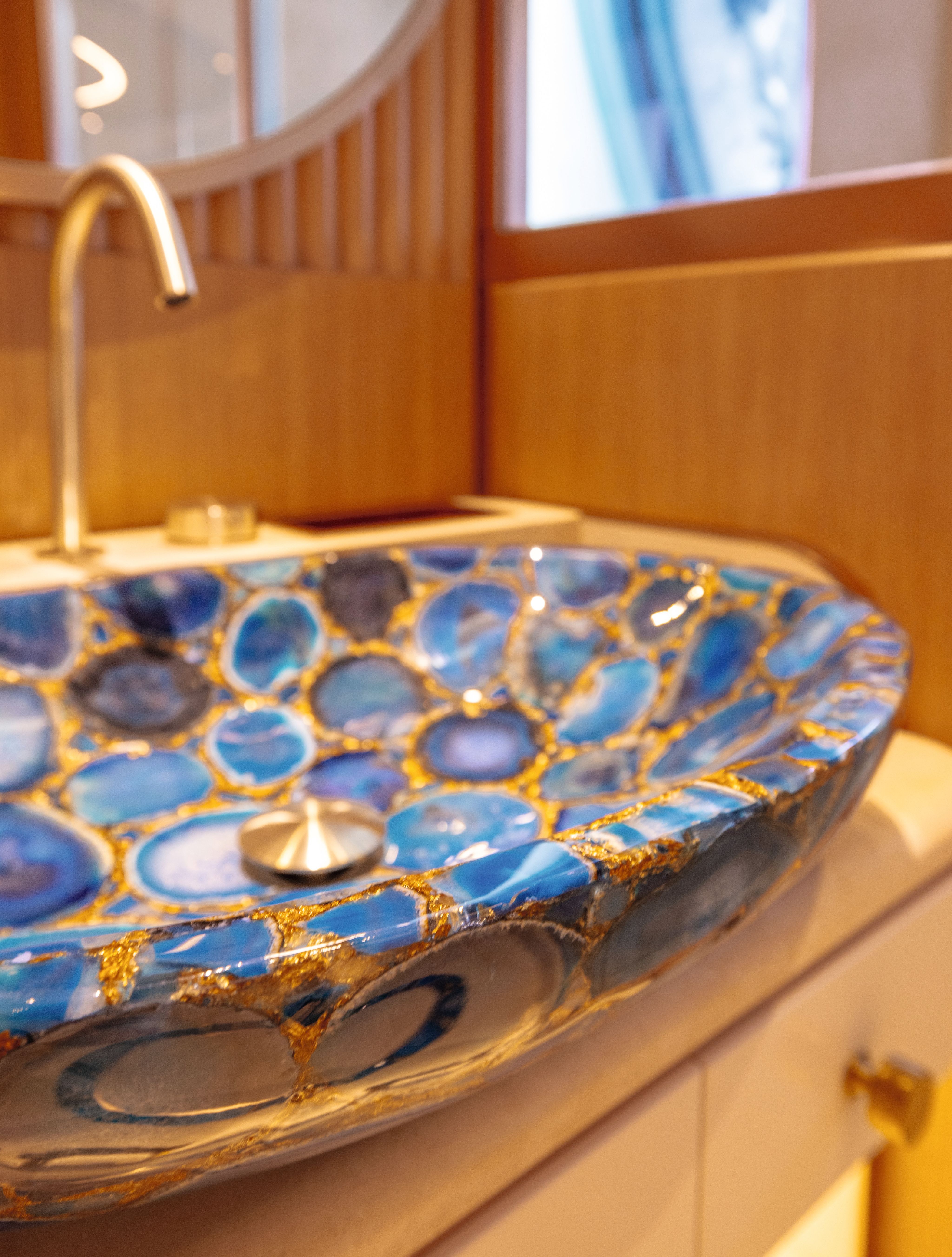 A close-up of the basin inlaid with blue gemstones