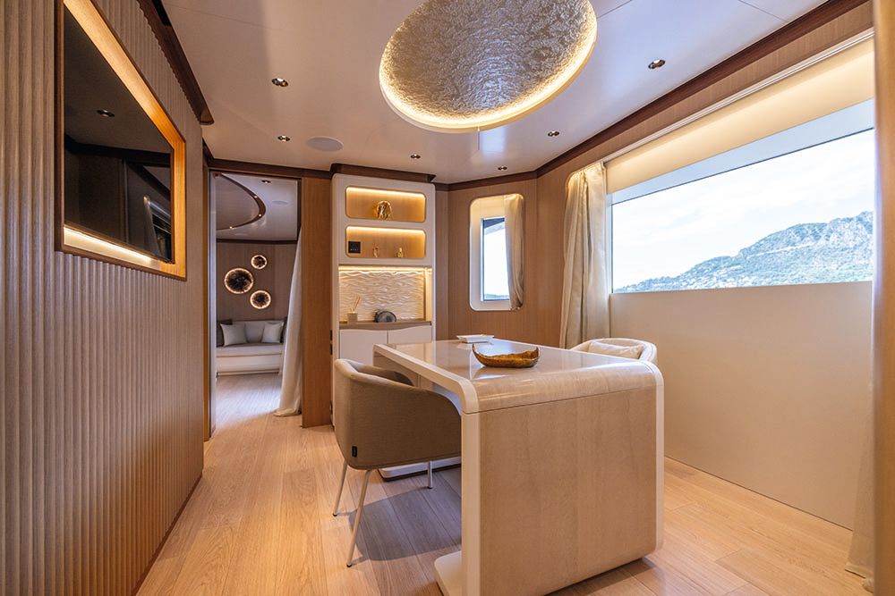 A table in the centre of a small room with a chair either side