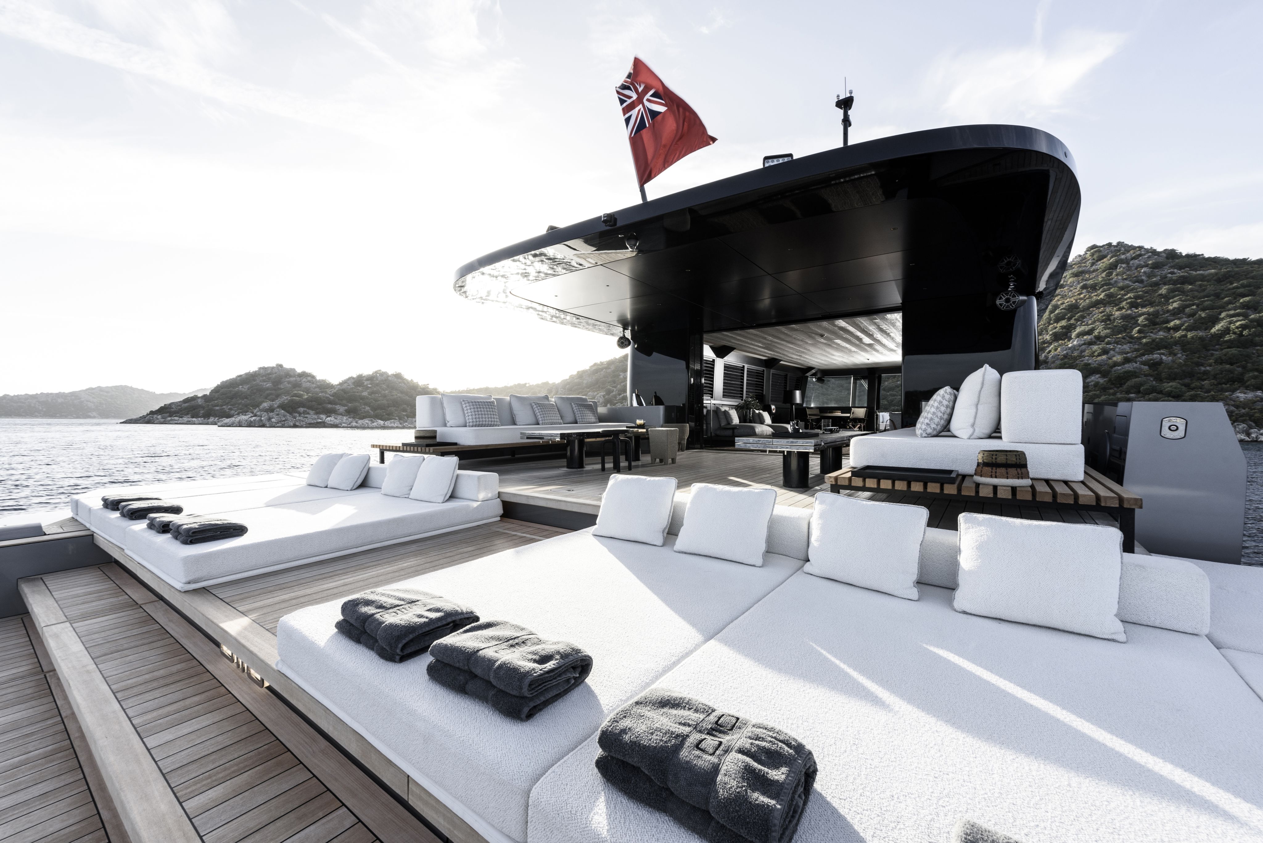 Sun deck with white loungers and grey towels