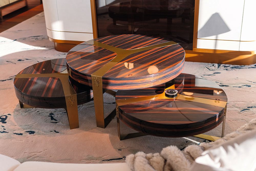 Three round mahogany coloured tables nestled together on a rug
