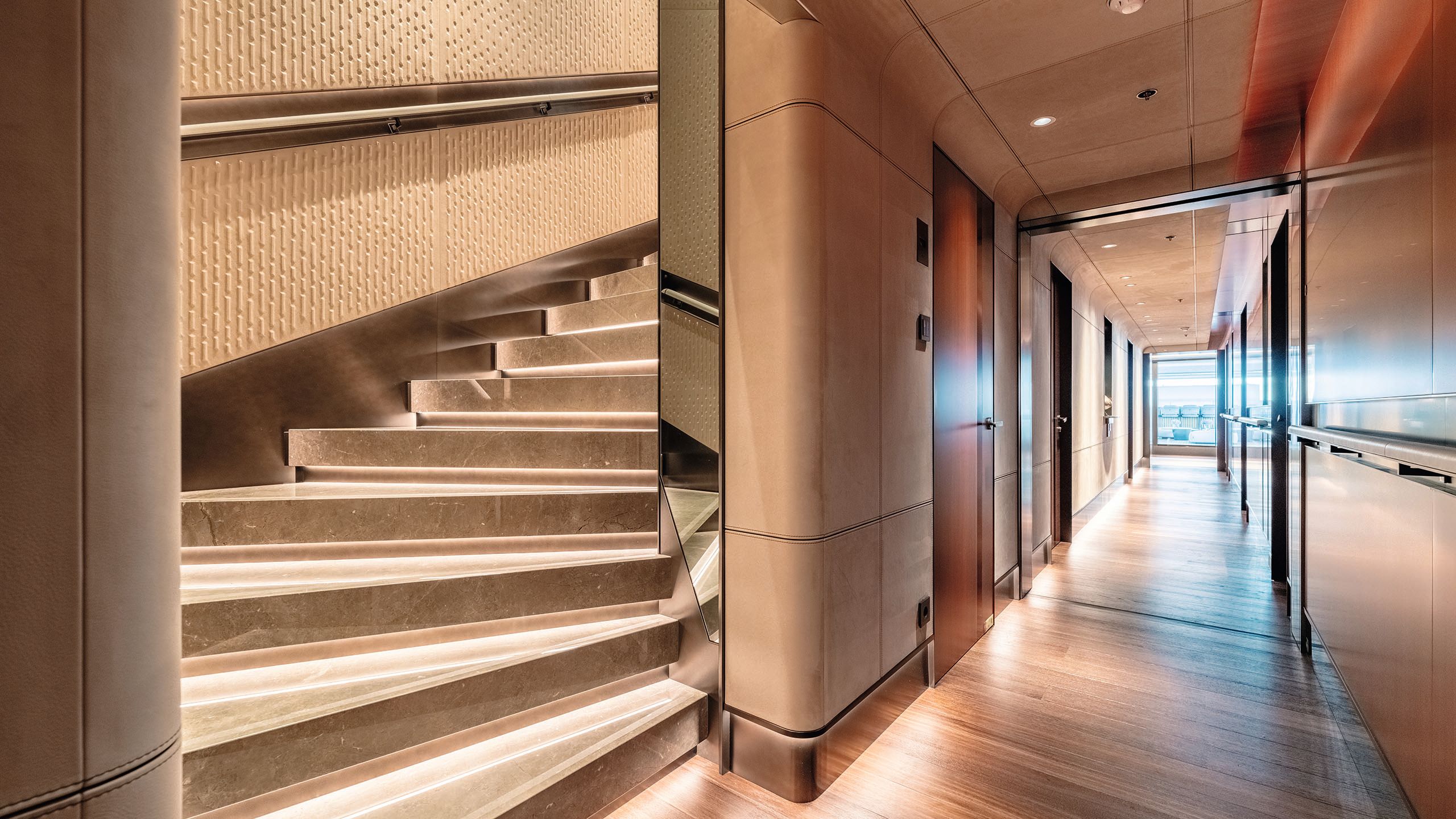 Staircase in neutral colours and treads lit from underneath