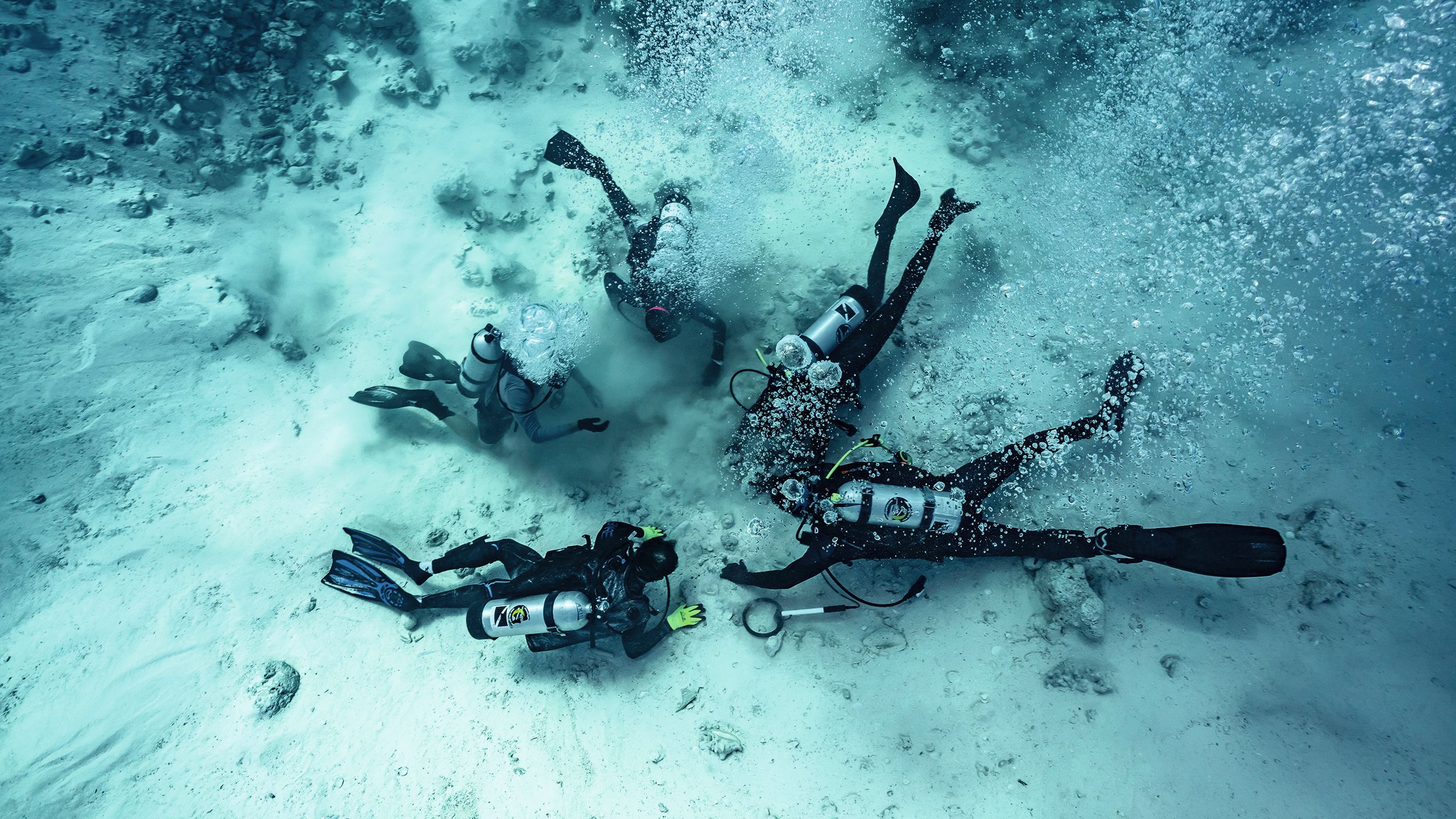 Divers on the bottom of the ocean