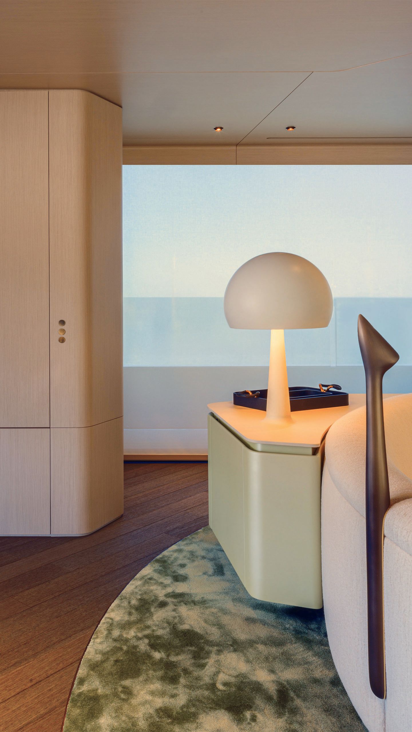 A mushroom-shaped lamp in beige moulded into the table