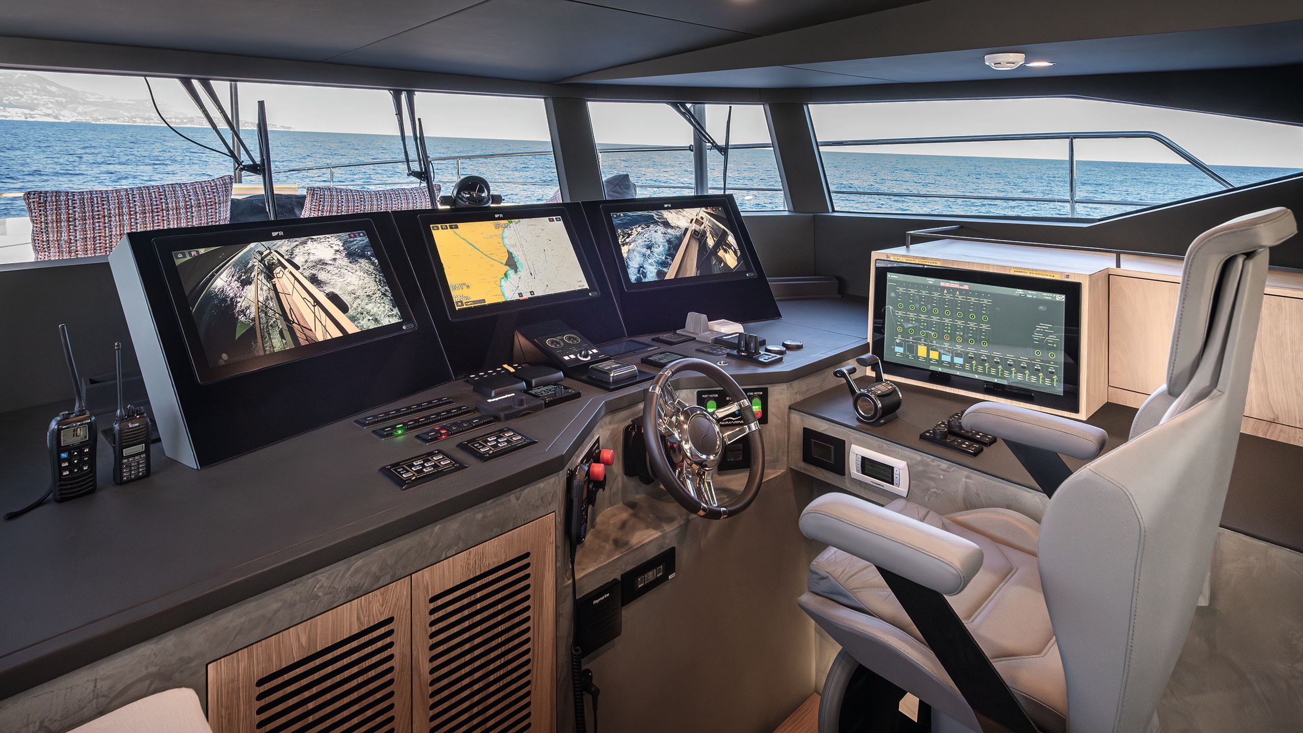 Alternative view of the bridge showing several screens and a control panel in front of the centre chair