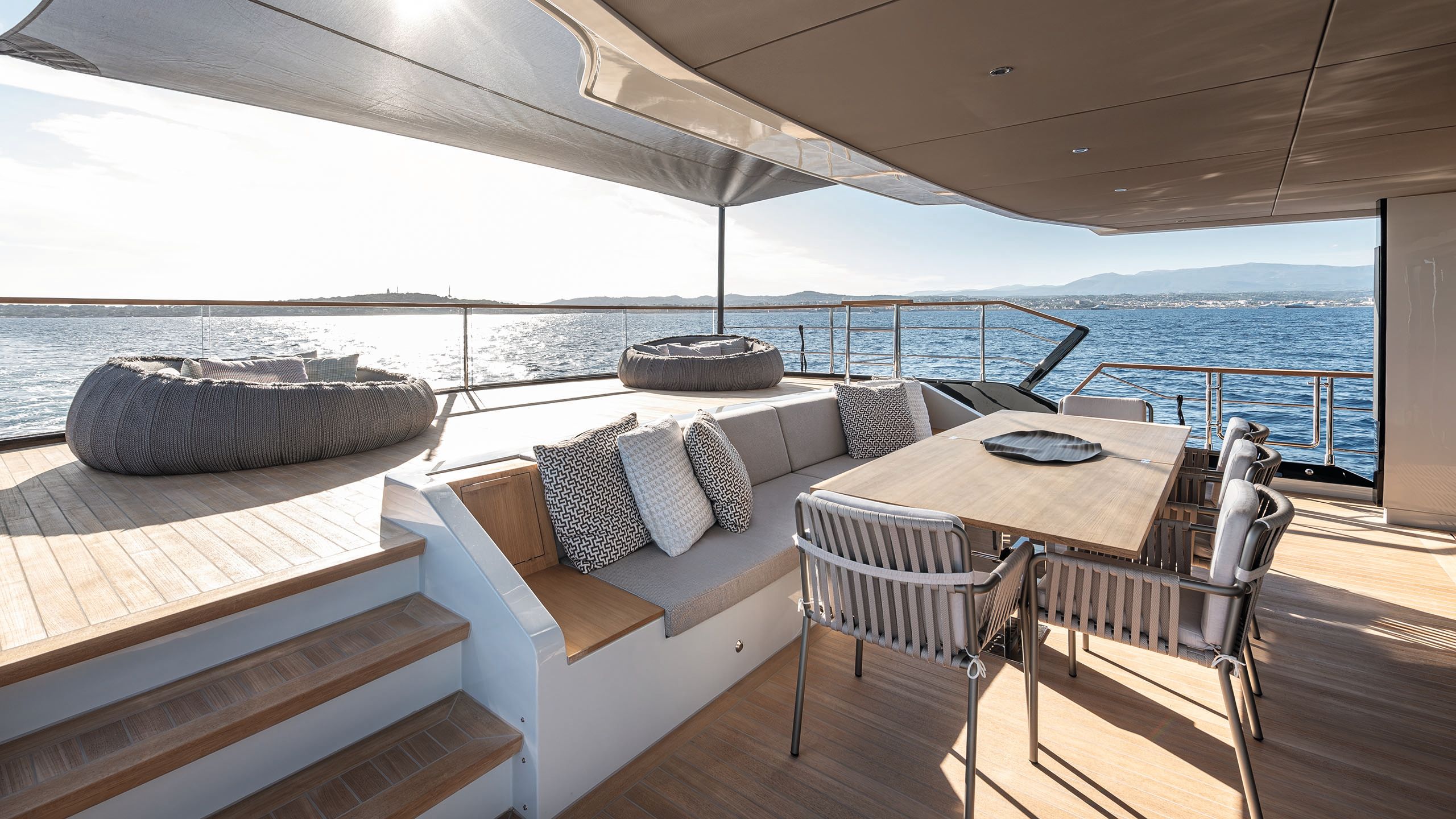 Alternative view of the beanbags on the deck with a banquette and table with chairs in the foreground
