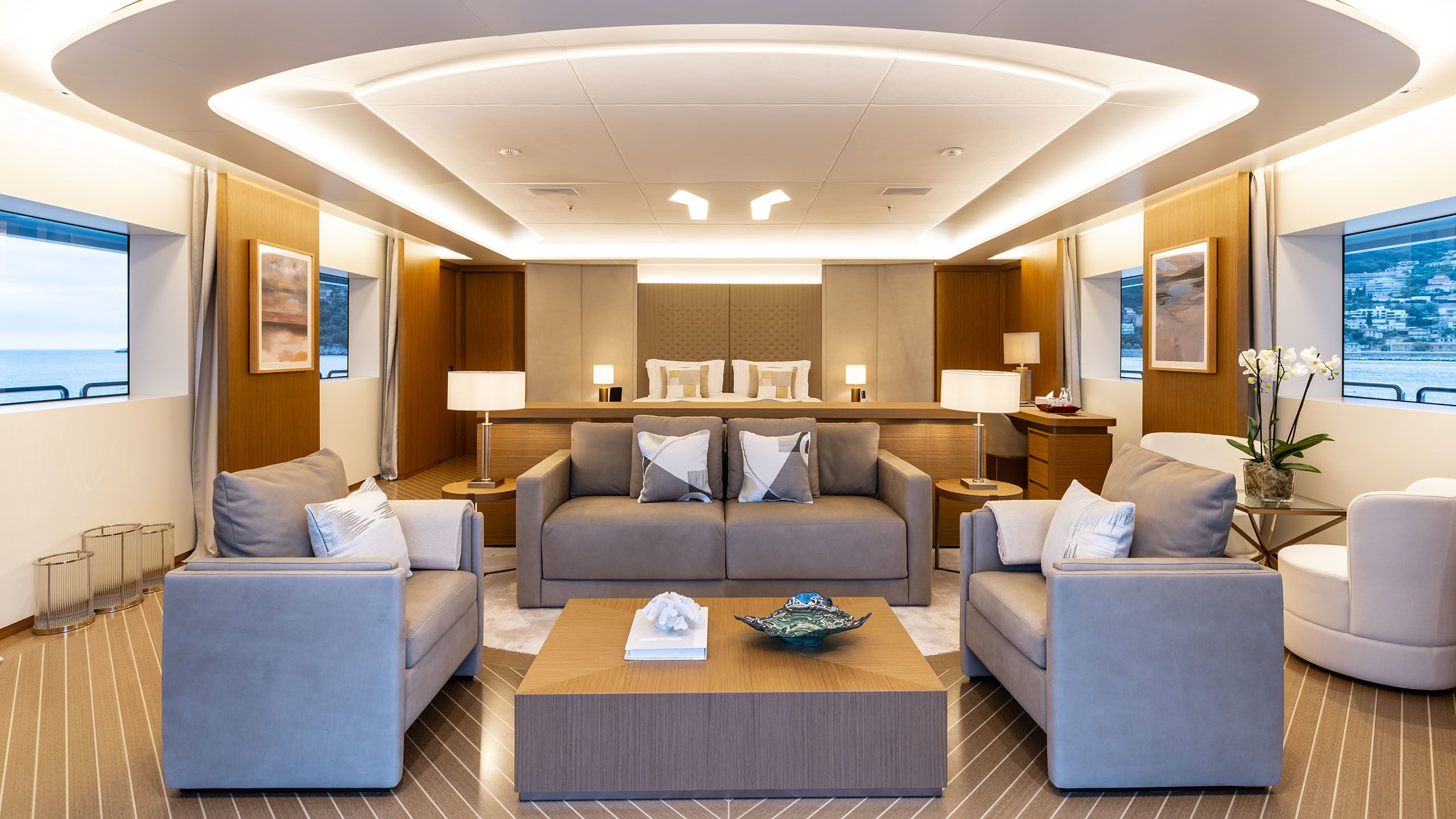 Interior of Alfa showing a large bedroom with sofa, chairs and coffee table in the foreground