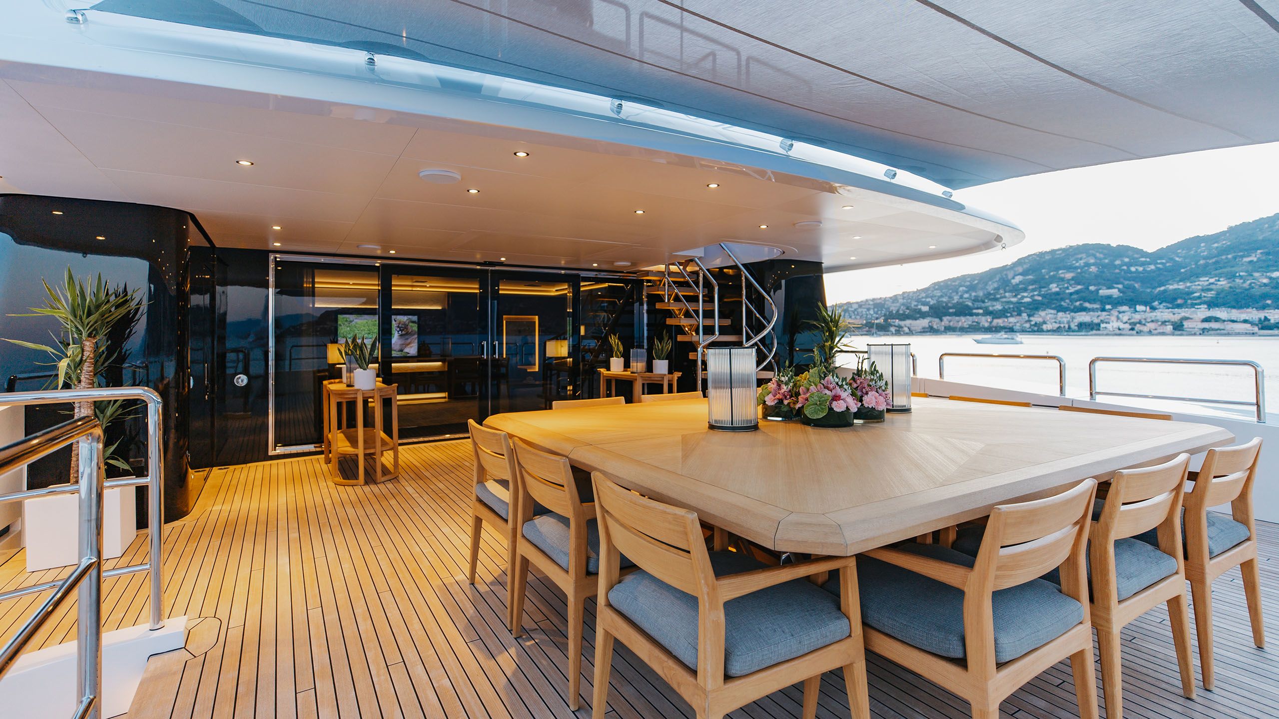 Covered section of Alfa's deck area, where there is a large square table with seating for 12