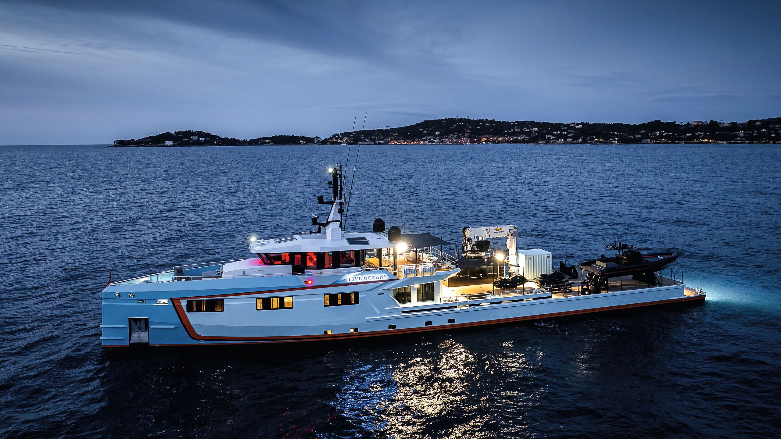Side view of Five Oceans on the water at night