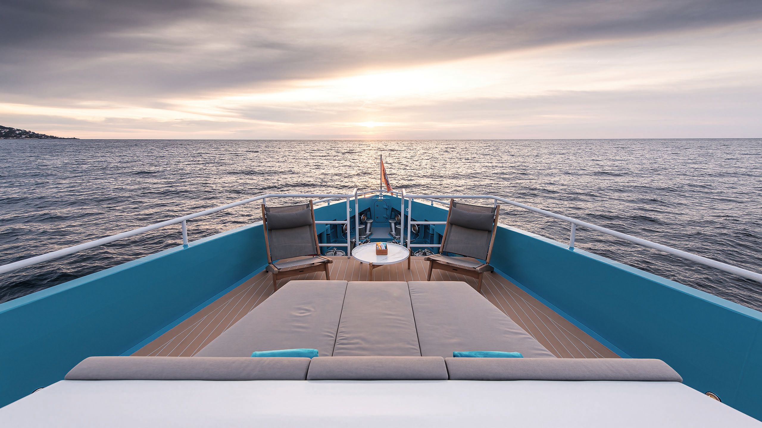 Two deck chairs at the tip of the boat facing inward