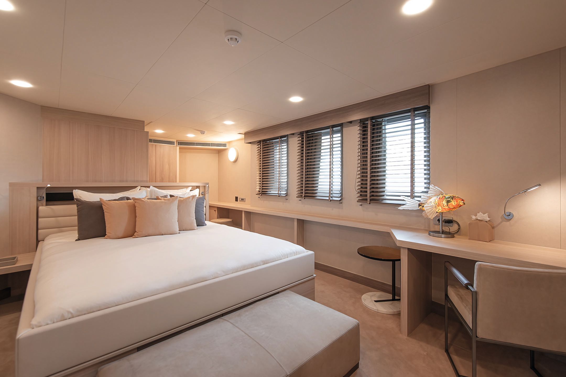 Cabin with double bed, shelving and a desk and chair