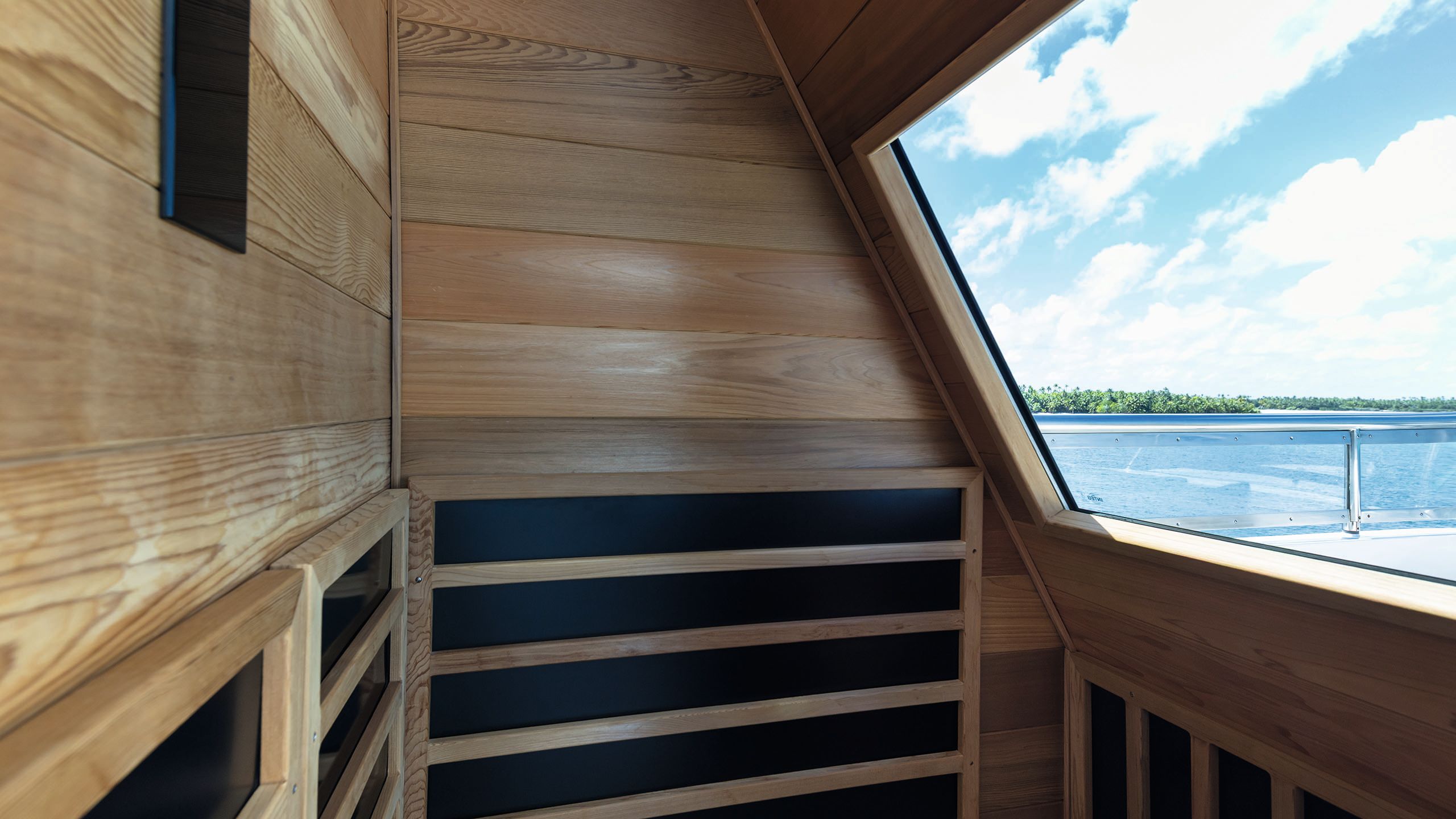 Inside the sauna which has a large window looking out to the sea
