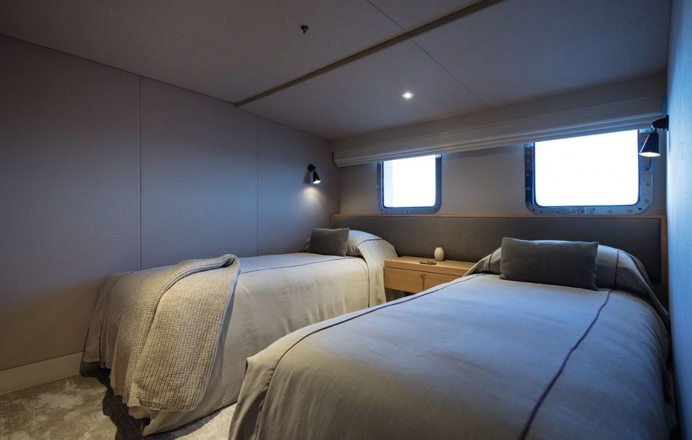 Two single beds next to each other in a small cabin