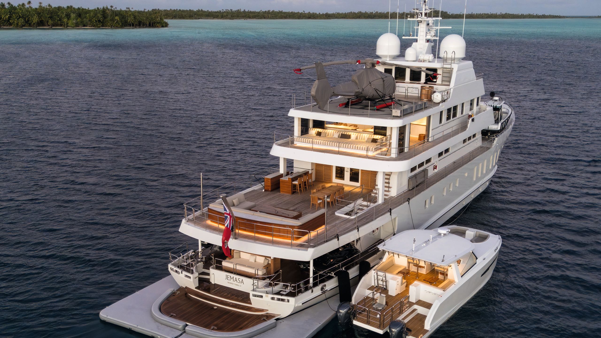 Alt view of JeMaSa from the back on the water next to a tender