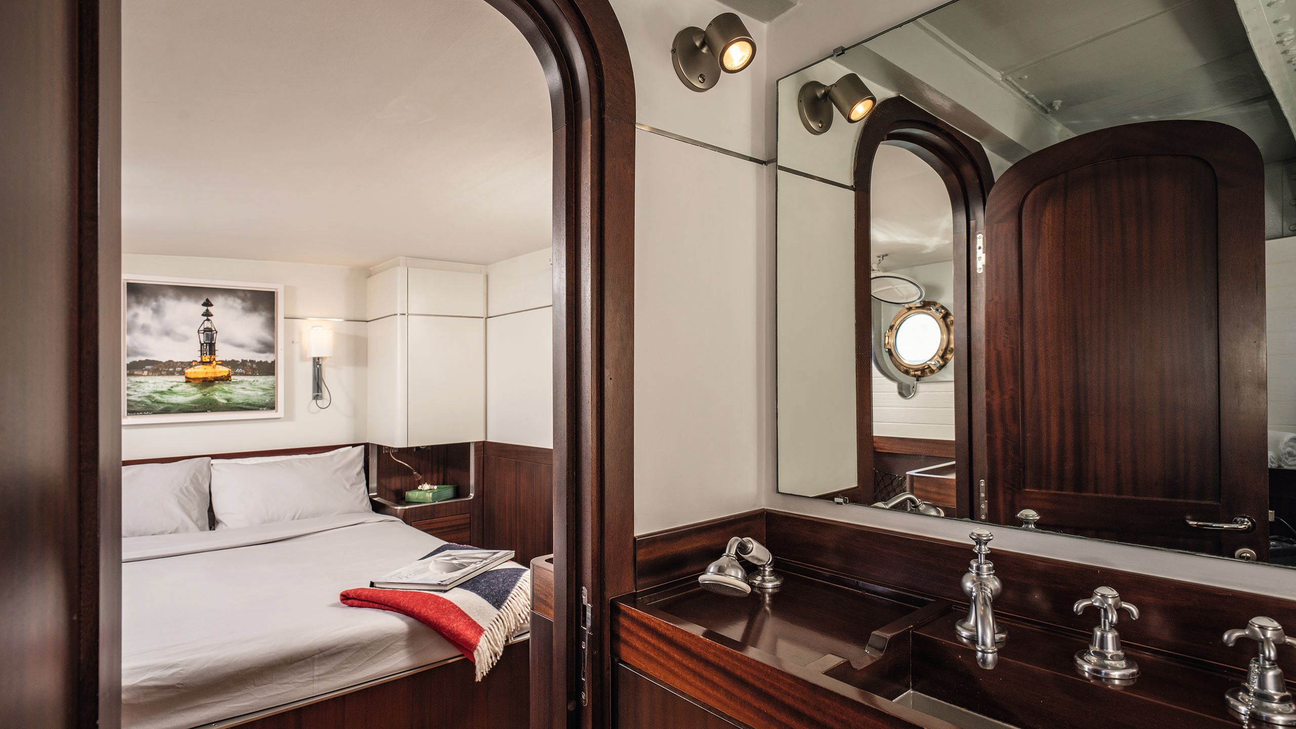 Looking into a bedroom that has a bed with whie linens