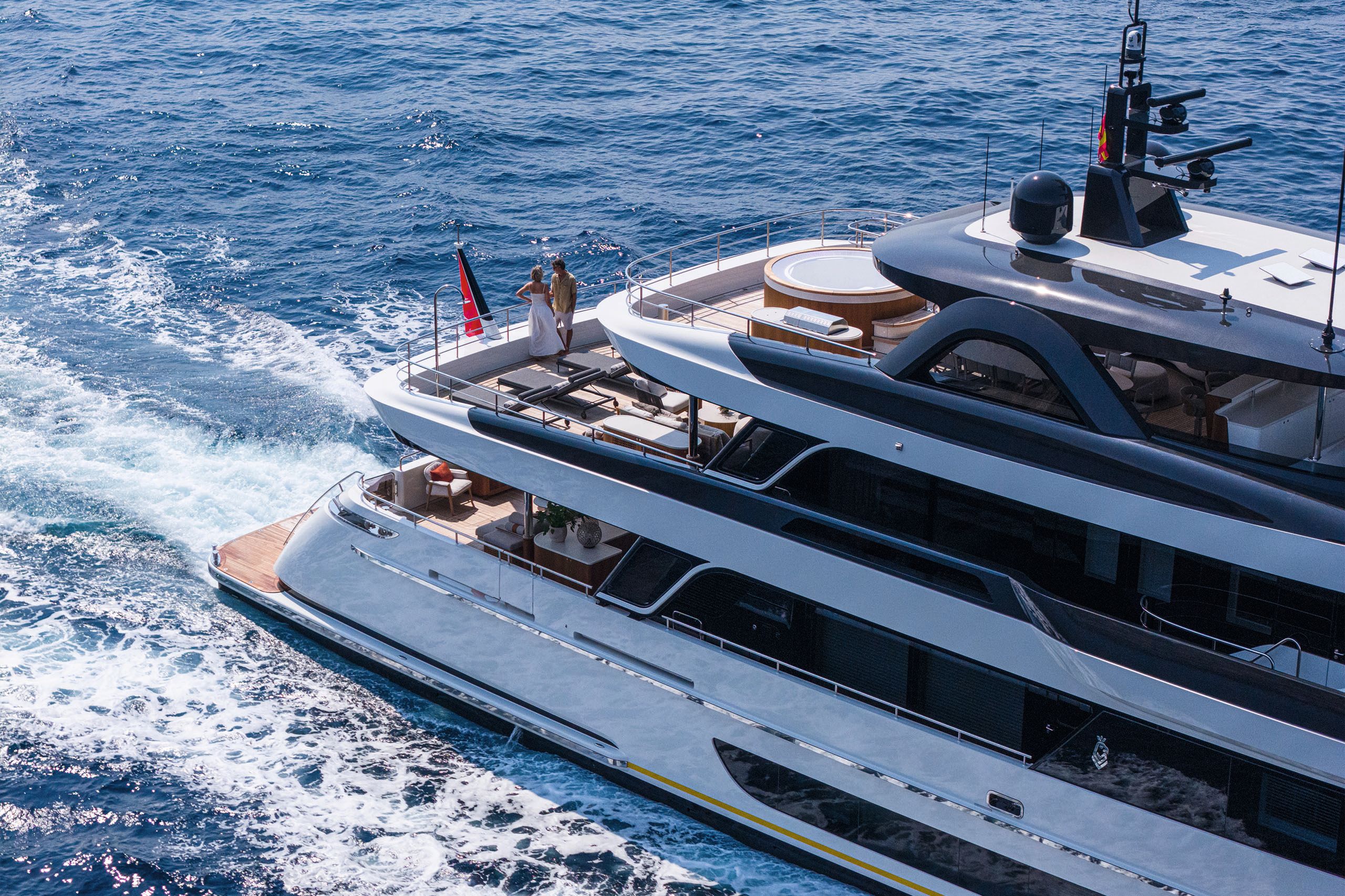 Partial overhead side view of Lalabe. Two people are standing on the tip of a deck looking out on the water