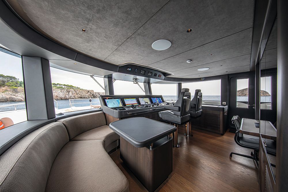 Inside the wheelhouse which has several monitors and two large chairs in front of the screens